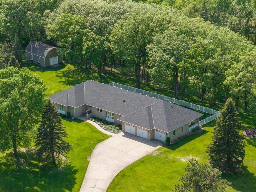 Experience refined riverfront living in this COMPLETELY RENOVATED ESTATE on 12.68 acres within the city limits of Little Falls along the scenic Mississippi River. Boasting over 790 feet of private river frontage, extensive westerly views, and breathtaking sunsets, this exceptional property offers unmatched privacy and tranquility. This 5,598 square foot home seamlessly blends high-end finishes with the original charm and character, creating a space that feels both timeless and inviting. The professionally designed floor plan includes 4 bedrooms, 4 baths, and a 3-car heated attached garage, with every detail thoughtfully curated. The luxurious primary suite features a spa-like wet room and oversized walk-in closet. Two additional main floor bedrooms, full bath and laundry make the perfect layout.  Entertain effortlessly in the chef’s kitchen with a large center island, custom soft-close cabinetry, high-end appliances, six-burner gas range, and spacious butler's pantry, or host guests in the elegant dining room, living room or the family den which offers built-ins and sweeping river views.  Spacious office, with abundant natural light and custom built-ins, is perfectly situated off the welcoming foyer. The Lower level offers a large recreation room, exercise room, wet bar, sitting room, and a large bedroom with walk-in closet. Gorgeous ¾ bathroom and lower-level laundry with a dog wash station and ample storage. Outdoor amenities include, covered outdoor grilling area with granite countertops, outdoor fire space, cart path to dock and waters edge,  partially fenced in yard, irrigated sprinkler system, yard is adorned with perennials, saltwater hot tub, beautiful mature hardwoods and a 20x30 storage barn. A rare opportunity to enjoy elevated craftsmanship, privacy, and acreage on the banks of the Mississippi River, all while remaining close to the conveniences of Little Falls.