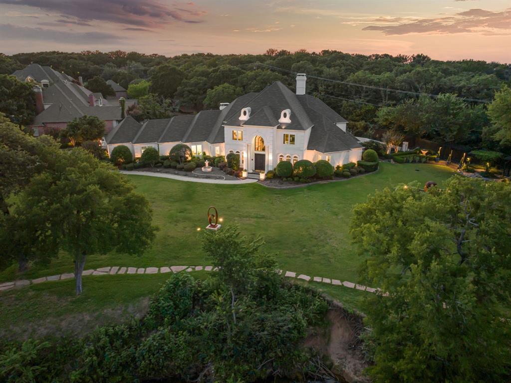 Experience a home that transcends luxury—5100 Oak Ln is a fully renovated, custom masterpiece that blurs the line between fine art and refined living. Set on 1.17 acres with tranquil pond views, walking gardens, and curated yard sculptures, this one-of-a-kind estate is an immersive living gallery.

Set on 1.17 acres with serene pond views, curated yard sculptures, and meandering walking gardens, the property invites you to live surrounded by beauty. Inside, you'll find 5,908 sqft of inspired living space with 5 bedrooms, 4 full baths, and 1 half bath.

The home’s main level showcases custom wood floors, an elegant dining room, and a refined study off the main foyer—each enhanced by dramatic, custom lighting that extends throughout the home to highlight both structure and atmosphere. The beautifully updated kitchen features high-end finishes, custom cabinetry, and seamless flow into the surrounding living spaces—perfect for everyday living and elegant entertaining.

The primary suite offers a peaceful retreat with a spa-like ensuite bath and dual his and hers closets. Outdoor living is equally extraordinary with a resort-style pool, covered entertaining areas, and a second-floor patio overlooking the natural surroundings.

Bespoke cabinetry, lighting, surfaces, and flooring combined with your own private speakeasy, theater room, and art studio bring depth and personality to the interiors.

Bold, expressive, and unlike anything else—5100 Oak Ln is more than a home. It’s art, reimagined as a lifestyle.