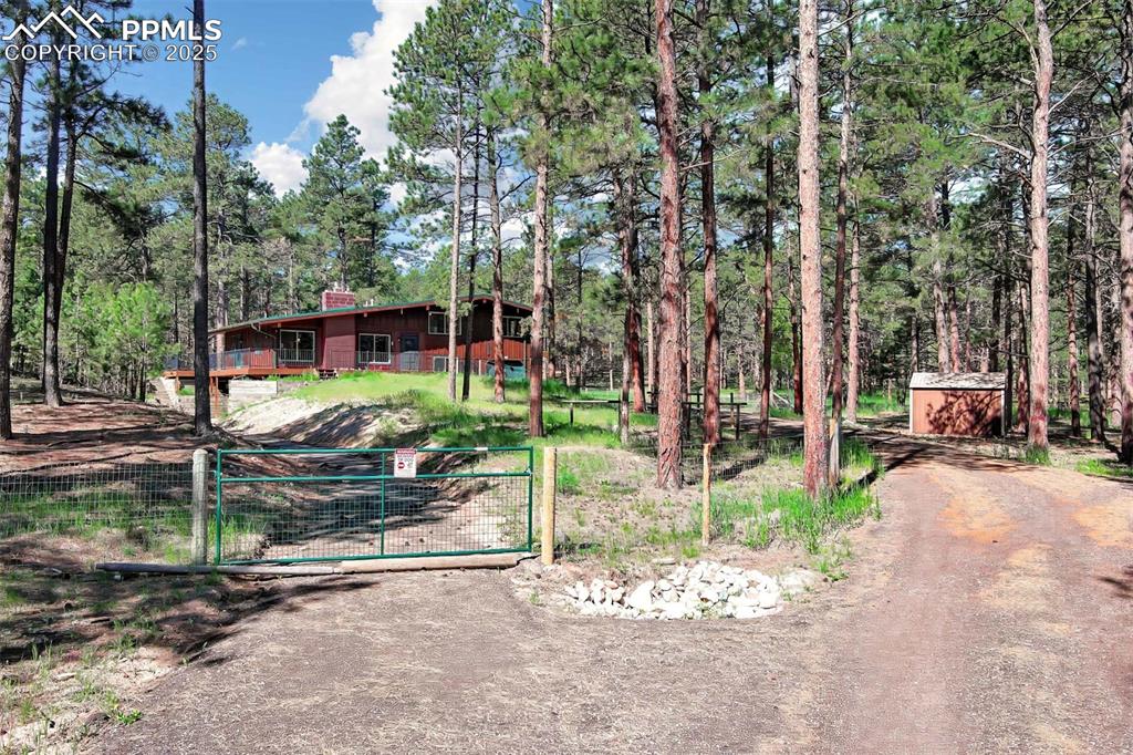 Welcome to this stunning 4 Bed/ 3 Bath 2,632 SqFt home that sits on 5 peaceful acres in one of Monument's most sought-after neighborhoods. The wood floors have just been refinished. You will enjoy the updated kitchen with stainless steel appliances that look into the family room with a brick fireplace. There are 3 well appointed bedrooms upstairs. One of the unique features of this home is two of the bedrooms have access to a outdoor balcony to really take in the outside beauty from the comfort of their bedroom. There is a fourth bedroom on the lower level next to a updated bathroom. The basement is finished with another cozy brick fireplace and has a walkout to a dedicated patio and additional driveway. There is an expansive Trex Composite Deck that wraps around the majority of the home as well as a new backyard deck for your enjoyment of the beautiful meadow. There is a RV electrical hookup and separate septic. Additional improvements include a new AC installed in 2024, a new Furnace installed in 2023, and the basement was finished in 2021. This is a must see property! You will surely enjoy the open space, privacy, and room to breathe all within reach of nearby modern conveniences. Whether you are dreaming of a quiet retreat or equestrian living, this property has it all!