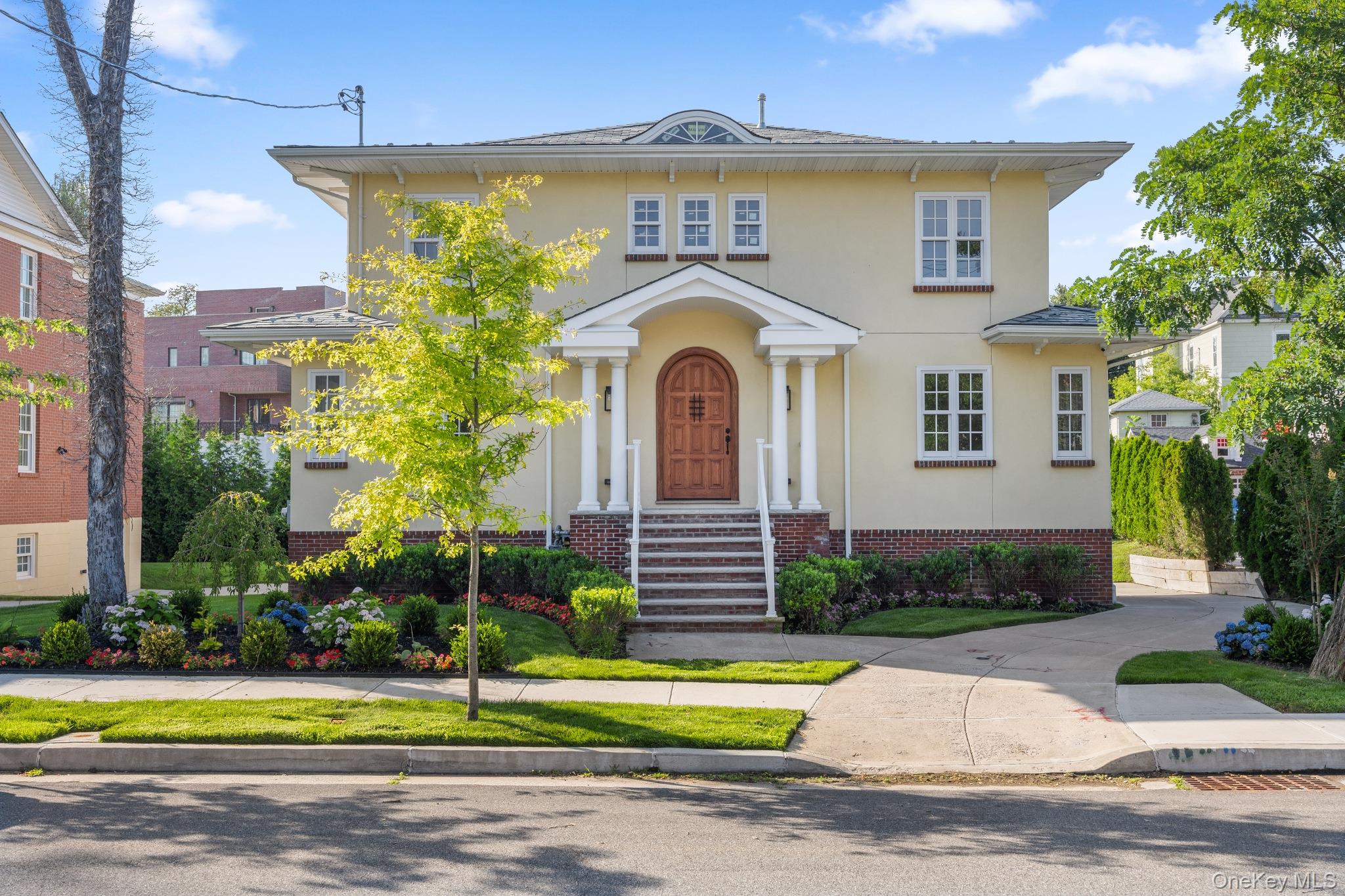 Welcome to an architectural masterpiece set in the heart of Douglaston. Custom-built with uncompromising quality and the finest craftsmanship, this remarkable 4-bedroom, 3-bathroom modern residence sits gracefully on a beautifully manicured lot, offering meticulously designed living space. Step into a breathtaking entrance foyer featuring soaring 20-foot open ceilings that set an immediate tone of grandeur. The main level showcases a seamless open-concept layout where the living room and dining area flow into a gourmet kitchen outfitted with premium quartz countertops, custom high-end cabinetry, and elite appliances. Perfect for indoor-outdoor entertaining, the kitchen extends gracefully onto a vast backyard deck and private yard. The sprawling primary suite serves as a peaceful retreat with serene views, dual custom-fitted closets, and a spa-inspired marble ensuite complete with a double vanity, a deep jacuzzi soaking tub, and a stall shower. Three additional graciously sized bedrooms each feature sunny exposures and ample closet space. A full walk-in-level basement adds exceptional flexible space for a recreation room, home gym, or guest quarters. Complete with central air conditioning. Ideally situated just blocks from the LIRR Station for an easy Manhattan commute, and minutes from major highways, fine dining, shopping, and top-rated schools. Experience the absolute pinnacle of Douglaston Luxury. Schedule your private viewing today!