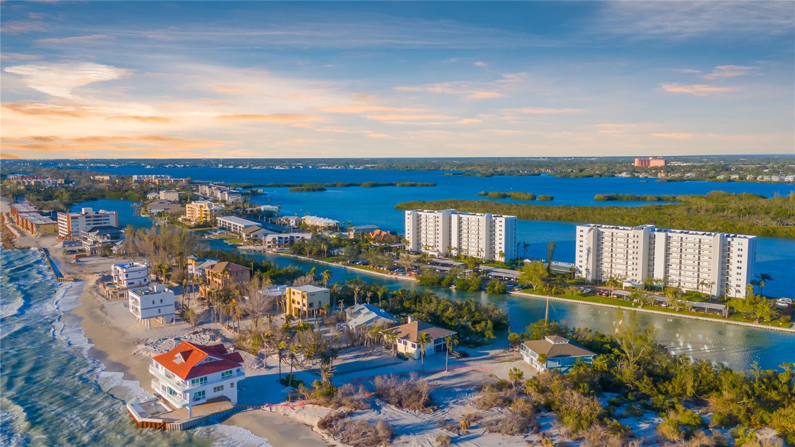 Absolutely stunning, furnished, and truly one-of-a-kind THREE-BEDROOM residence at The Pointe at Midnight Pass — the only 3-bedroom currently available in this highly sought-after community.Positioned on the 9th floor at the southern tip of Siesta Key, this impeccably renovated corner unit sits at a rare coastal convergence where the Gulf, Little Sarasota Bay, and Blind Pass Lagoon meet. Enjoy panoramic sunrise views across the Intracoastal waters, glowing Gulf sunsets, and protected preserve vistas — all from one extraordinary setting.High-end finishes define the interior, including solid wood cabinetry, granite countertops, stainless appliances, and thoughtfully curated details throughout. The spacious primary suite features a beautifully updated en-suite bath with a jetted shower and a custom walk-in closet designed for optimal storage.Two additional bedrooms function seamlessly as guest suites, office, or den. The Gulf side bedroom is equipped with a custom Murphy bed and built-ins, offering flexibility without sacrificing style. The second bath features a Jacuzzi tub for relaxed coastal living.The expansive, air-conditioned lanai invites year-round enjoyment, offering a serene vantage point overlooking the Jim Neville Preserve and surrounding waterways. A pass-through utility room with washer, dryer, laundry sink, and folding counter adds everyday practicality.New hurricane-impact windows and sliding glass doors, along with an energy-efficient HVAC system, provide comfort and peace of mind. A rare double parking space under the building further distinguishes this offering.The Pointe is a gated, pet-friendly, five-acre waterfront community featuring boat and kayak docks, resort-style pool, tennis and pickleball courts, fitness center, saunas, clubhouse amenities, and a private island gazebo.More than a condominium, this is a private waterfront retreat positioned in one of Siesta Key’s most iconic locations.
