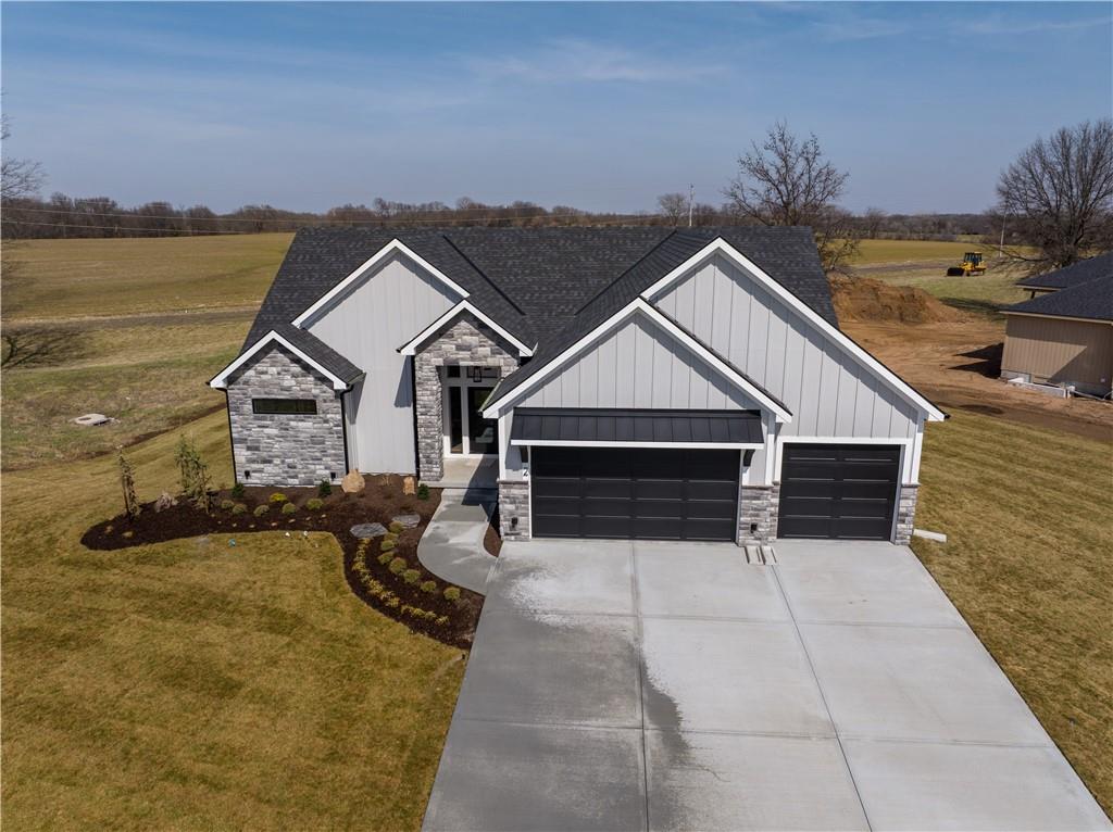 Discover elevated living in The Heather floorplan by Walker Custom Homes – a thoughtfully designed reverse 1.5 story home offering 4 bedrooms, 4 bathrooms, and 3,395 square feet of refined living space. This amazing lot with full lake rights, backs to HOA greenspace, making your backyard a serene retreat.  This spacious layout features a large primary suite on the main level, complete with easy access to a stunning covered deck with an outdoor fireplace, perfect for year-round enjoyment. The open-concept main floor is ideal for hosting or relaxing in comfort, while the lower level includes a stylish bar and additional bedrooms, creating a versatile space for entertaining and guests. A true custom home experience! Nestled in the vibrant Lake Winnebago community, enjoy exclusive amenities including boating, fishing, scenic walking trails, horse stables, tennis and basketball courts, plus a brand-new community pool coming soon.