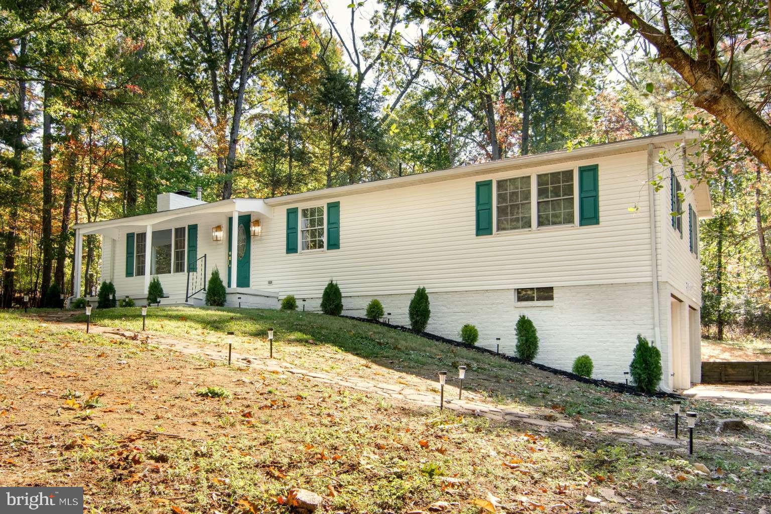Welcome to 36 White Oak Drive, a beautifully renovated 3-bedroom, 2-bathroom home situated on a 1.64-acre wooded lot at the end of a cul-de-sac in Dickinson Township. Offering approximately 1,900 square feet of living space, this home combines updated interiors with a scenic natural setting.A charming front porch welcomes you into a bright, inviting interior featuring abundant natural light and updated flooring. The spacious living room boasts vaulted ceilings and a wood-burning fireplace, creating a comfortable setting for relaxing or entertaining. A dining area within the living room provides space for everyday meals and gatherings. The updated kitchen features stainless steel appliances, a stylish range hood, and direct access to the rear deck—ideal for outdoor dining and entertaining. The spacious primary suite features a walk-in closet and an updated private bathroom with a walk-in shower. Two additional generously sized bedrooms offer flexible living arrangements and are complemented by a second full bathroom with a bathtub.The basement family room, featuring a wood stove, provides additional space for recreation, hobbies, or entertainment. A dedicated laundry area and a separate storage room offer practical space for organization and household needs. An oversized attached two-car garage, accessed by an asphalt driveway, provides covered parking and additional storage space. Step outside and enjoy the wooded surroundings and spacious backyard, offering room for outdoor activities, gardening, and relaxation.The property offers access to nearby destinations including Yellow Breeches Creek, historic Mount Holly Springs, and various parks and recreational areas. Downtown Carlisle, with its shopping, dining, and local amenities, is also within driving distance. With its updated interior, spacious lot, and natural surroundings, this home offers a wonderful opportunity to enjoy comfortable living in a scenic setting. Schedule your showing today!