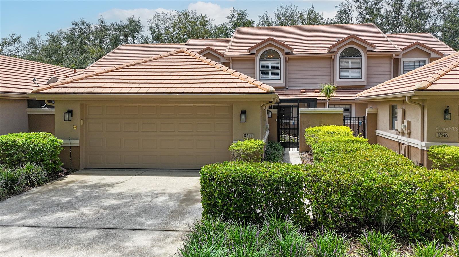 This stunning townhome is located in the gated community of Hunter's Green, 
within the North Oakcrest subdivision. Move-in ready, this immaculate residence 
features 1,652 sq ft, with 3 bedrooms and 2 bathrooms. It also includes a detached 
2-car garage, an oversized screened-in front courtyard, and a covered lanai in the 
backyard that overlooks the common area. 
Upon entering the foyer, you'll immediately notice the pride of ownership reflected 
in the upgrades throughout the home. The formal living room showcases crown 
molding and wainscoting, with engineered hardwood flooring throughout, except in 
the kitchen and bathrooms, which are tiled with porcelain. All windows are fitted 
with plantation shutters. The spacious great room features cathedral ceilings, a 
gorgeous chandelier, and double sliders that lead to the lanai. 
The remodeled kitchen is equipped with stainless steel appliances, including a new 
range (2025), a dishwasher (in 2022), new faucets (2022), and a garbage disposal 
(2024). The laundry closet houses a stacked washer and dryer, along with storage 
cabinets. 
The first-floor bedroom includes a spacious walk-in closet, hardwood floors, a 
ceiling fan, and a beautifully remodeled full bathroom. Upstairs, you will find the 
primary bedroom, which features a walk-in closet and an en-suite bathroom. The 
remodeled primary bathroom boasts granite counters, dual sinks, white cabinetry, 
and a standalone soaking tub with a separate shower. The third bedroom is 
generously sized, equipped with a Murphy bed and a ceiling fan. 
Additionally, the detached 2-car garage (20 x 20) offers plenty of storage space. 
This low-maintenance community provides lawn care, common area maintenance, 
roads, exterior painting, and a pool exclusively for North Oakcrest residents. 
Hunter's Green is a 24-hour guard-gated community that features various 
amenities, including community facilities, designated bike lanes, playgrounds, and 
lighted tennis, basketball, volleyball, soccer, and baseball fields. There is also a 
jogging trail with a 15-station exercise circuit and an off-leash dog park. 
Membership at Hunter's Green Country Club offers options for golfing on the 18-
hole Tom Fazio-designed course or access to their Tennis and Athletic Center.