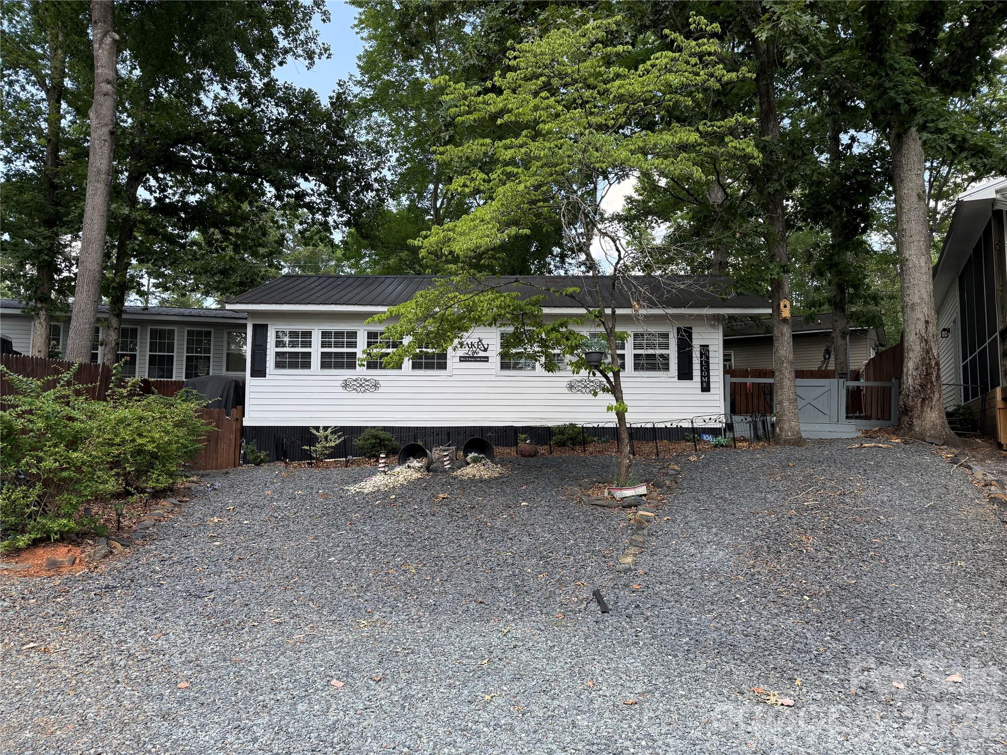 Welcome to the freshly updated and turnkey property in Twin Harbor. Great quiet lot on cul-de-sac.  This unit is ready to go, so unpack your bags and start having fun in your "Happy Place" here in the park. A decorators delight from the moment you drive up. Large two tier fenced deck with shade trees to enjoy the great outdoors. Enter into a nice size living room with all the comforts of home. Cozy seating to host your guests. Electric fireplace with blower. Additional propane heater. Wall mounted TV and a new mini split for all your climate control needs.  All furnishings to remain. Updated vinyl tilt windows for easy cleaning. There is a pass through window to the kitchen with a bar and seating for two.  The kitchen has a full size stove and sink. Nice size pantry. The dining area with table and chairs to read the paper and have coffee.  Large main bedroom with barn doors.  Updated bathroom with full size tub. Secondary bedroom is currently being used as the laundry room/closet. Washer/Dryer to remain.  Also includes a 2002 Club Car Golf Cart. Perfect for a weekend getaway or for full time living. No title to camper, bill of sale will be provided.All buyers must be with a realtor to gain entry into the park.