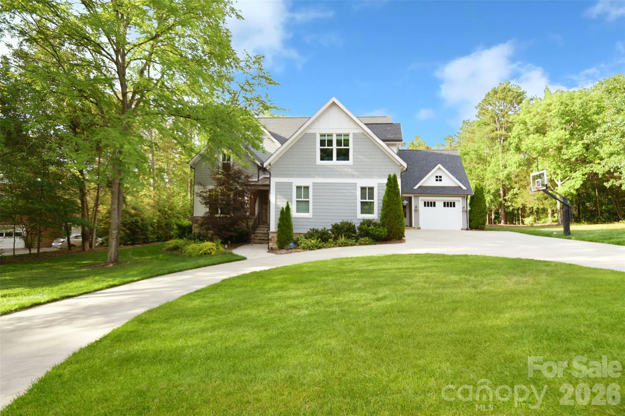 Experience refined estate living in Davidson’s prestigious River Run neighborhood. Nestled on a private lot with a circular drive, this remarkable custom residence offers a perfect balance of timeless elegance, everyday comfort, and exceptional outdoor amenities. Designed with both entertaining and relaxed living in mind, the home showcases spacious interiors, upscale finishes, and an effortless connection between indoor and outdoor covered spaces.At the heart of the home, the gourmet kitchen is equipped with top-tier appliances, an oversized quartz island, and gorgeous cabinetry, flowing seamlessly into bright gathering spaces ideal for hosting or daily living. The thoughtfully planned layout includes a serene second-level owner’s retreat, a private guest quarters/flex space, a custom butler's pantry, and refined living spaces.Outside, the property transforms into a true resort-inspired escape. Enjoy endless recreation with a custom swimming pool and spa, and multiple outdoor entertaining spaces. Gather around the fire pit and cook in the fully equipped outdoor kitchen.Additional features include a three-car garage, and expansive outdoor living areas designed for year-round enjoyment. Residents of River Run enjoy access to premier amenities including golf, tennis, swimming, and walking trails, all conveniently located near downtown Davidson, Lake Norman, local restaurants, and boutique shopping.