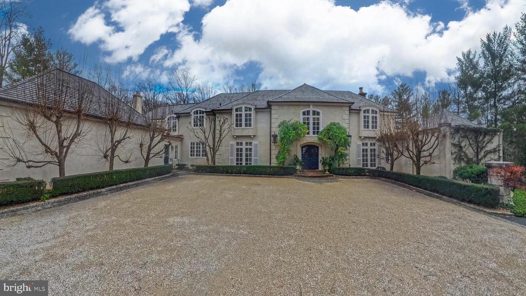 Situated in the heart of Gladwyne, this distinguished residence offers timeless architectural elegance and thoughtfully curated indoor and outdoor living spaces...an additional 1+ acre lot (1115 Waverly Road) is included in the sale.A grand double-door entry opens to a marble-tiled foyer with soaring ceilings and a sweeping staircase.The formal living room is highlighted by a dramatic two-story ceiling and expansive floor-to-ceiling windows. A beautifully appointed office features custom wood built-in bookshelves and a fireplace with a striking black marble surround. A second living room, ideally located near the kitchen, is rich in character with cathedral ceilings accented by wood beams, custom wood paneling, detailed crown molding, a fireplace, and a built-in bar alcove, creating an inviting setting for entertaining.The kitchen is equipped with custom cabinetry, granite countertops, a Dacor gas cooktop, and a         double-door custom Sub-Zero refrigerator. The dining room is a true showpiece, featuring a hand-painted mural ceiling, dual chandeliers, and oversized doors that open to the back patio.The first-floor primary suite offers a serene retreat with direct backyard access and two ensuite bathrooms, including an updated spa-like bath with a walk-in shower, bench seating, and overhead shower, as well as a second bath with a soaking tub and walk-in shower. Upstairs, six additional bedrooms are complemented by multiple full bathrooms, including several updated baths.The finished basement adds flexible living space with a recreation area, home gym, and full bath. Outdoor living is elevated by a pavilion-covered patio designed for year-round enjoyment, featuring a substantial brick fireplace with built-in TV, a pool, and professionally landscaped grounds. A three-car garage completes this exceptional Gladwyne offering.