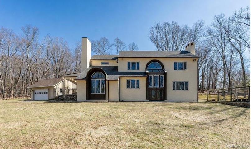 This private and spacious home sits on 2.5 acres of beautiful land in Pound Ridge, and is the ideal Westchester retreat. It has that perfect mix of "peace and quiet" without being completely off the grid. With 4 bedrooms and 3 full bathrooms, you’ll have plenty of room for everyone. The versatile floor plan offers endless possibilities to make the space your own. Enjoy a bright eat-in kitchen with skylights that fill the room with natural light—perfect for morning coffee. The large quartz-topped island is perfect for meal prep and entertaining, and features a gas cooktop. A wood-burning stove in the den is cozy and warm on cold nights. Large windows throughout the home create a light and airy atmosphere. This home features an elegant formal dining room—perfect for hosting holiday feasts and candlelit dinner parties. The living room centers around a classic fireplace, offering a warm, relaxing retreat for evenings at home. An unfinished space just off the living room offers exciting potential. Createa sunroom, screened-in porch, home office, or additional living area tailored to your vision. The newly built two-car garage (2022) provides ample storage. New roof in 2025. Whirlpool dishwasher 2021, Stove top on Island 2023, Oven and in-wall microwave 2020/2021. GE Refrigerator 2023.