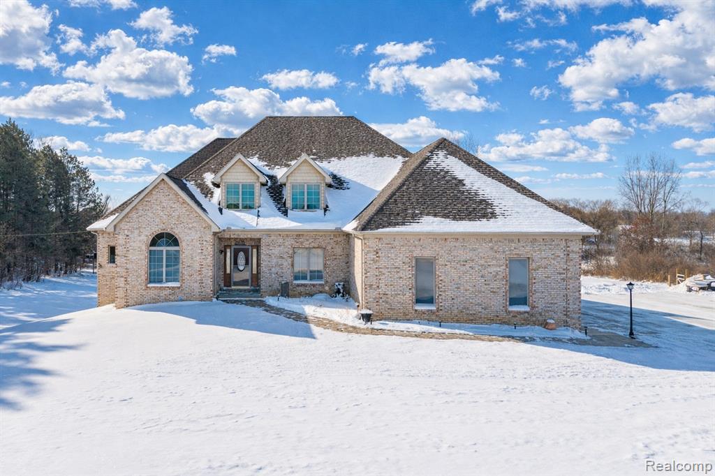 Open Sunday, 02/01/2026 from 1-3 P.M. This 3,500+ sq. ft. custom  Grand Blanc estate is the definition of refined country living. Set on 5.2 acres, this property offers a rare blend of privacy, elegance, and everyday comfort, and was designed for those who desire space, beauty, and serenity without sacrificing convenience. Inside, enjoy a light-filled, open-concept island kitchen complete with full stainless steel appliance package, breakfast room, and sweeping panoramic views of the surrounding grounds. Entertain with ease in the formal dining room or unwind in the spacious great room, anchored by a cozy gas fireplace—perfect for intimate evenings or lively gatherings. The first floor primary suite features a generous walk-in closet and a spa bath with jetted soaking tub and separate shower. Wood and tile flooring elevate the home throughout, while thoughtful upgrades—including a new Lennox furnace and tankless water heater add peace of mind. Upstairs, 2 bedrooms share a full bath, offering comfort and privacy for family or guests. The finished walkout lower level is an entertainer’s haven, boasting an expansive recreation space, fourth bedroom, luxurious full bath, and a custom wet bar—ideal for hosting or extended living. Outdoors, the lifestyle continues. A 30x48 detached three-car pole barn built in 2018 with three overhead doors plus an attached three-car garage, provides exceptional storage for vehicles, toys, and hobbies alike. The grounds are nothing short of spectacular: a covered vaulted back deck, custom patio with bar, wood-burning fireplace, fire pit, fenced raised garden beds, and 42 fast-growing arborvitae trees create natural privacy on both sides of the property. Built with seamless indoor-outdoor living in mind, this custom home offers unmatched seclusion, abundant wildlife, and tranquil surroundings—yet remains just minutes from Grand Blanc amenities, Henry Ford Genesys Health Campus, and I-75 access.