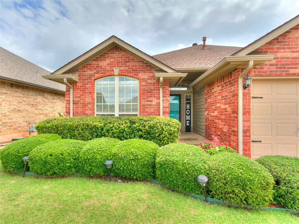 This Charming 3-bedroom, 2-bathroom home, built in 2004, features a desirable split floor plan with elegant crown molding in main living areas, spacious rooms, and plenty of storage throughout.  The large living room centers around a cozy gas log fireplace, while the kitchen offers a breakfast bar, pantry, and refrigerator that stays with the property. The primary suite includes a generous bedroom with private access to the covered patio, a walk-through walk-in closet, double sinks, and a large jetted tub for relaxing.  Secondary bedrooms are well-sized and inviting!  Additional highlights include a roomy utility area , newer carpet, and an A/C unit that's only three years old.  Enjoy outdoor living with a covered patio, private fenced yard, and complete guttering around the home.  Beautiful landscaping surrounds this corner lot property, which also includes a desirable 3-car garage.