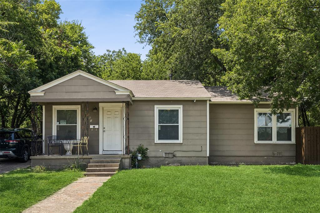 Beautiful corner lot bungalow with gorgeous trees for plenty of shade! This move-in-ready property features original hard wood floors throughout most of the home, a bonus mud room and utility area and an oversized two car detached garage with electricity. Each bedroom has a ceiling fan, new window blinds and standard closets. The kitchen offers a gas stove, a long bank of cabinets and counter space, and the newer stainless steel refrigerator stays with the property! The oversized fenced lot offers a generous area for outdoor activities along with a concrete patio for furnishings. The long paved driveway is covered by a canopy of trees offering even more shade, additional off-street parking and convenient access to the home. BUNDLED SERVICE PRICING available for buyers. Connect with the listing agent for details!