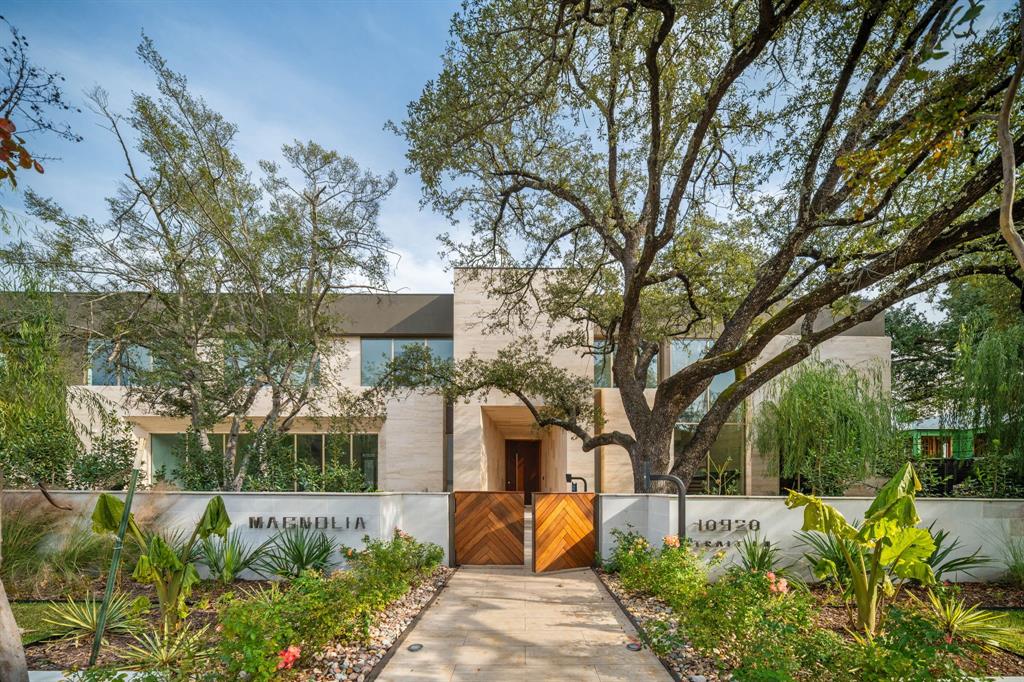 Set on legendary Strait Lane, 10920 is a modern estate that lives like a private resort—11,211 square feet on approximately .72 acres in prestigious Preston Hollow. Behind dual entry gates, clean lines and soaring ceilings create a striking first impression, while floor-to-ceiling custom windows draw in natural light and connect every space to the outdoors.This home is defined by timeless materials and intentional design. Ojinaga limestone and Travertino Jalapa walls establish warmth and texture, complemented by white oak millwork that runs throughout—from custom cabinetry to beautifully finished closet interiors. The open chef’s kitchen is built for entertaining with premium appliances, generous workspace, and a dedicated wine room for effortless hosting. Visual Comfort lighting and statement chandeliers elevate the mood from day to night.A downstairs primary retreat offers a spa-inspired bath with enclosed dual showers and an expansive custom closet with island. Multiple living spaces include formal dining, a sunlit living room with bar, private office with built-ins, media and game rooms, and a main-level guest or staff ensuite. Two utility rooms—one per floor—add everyday ease.Step outside to a covered loggia, outdoor kitchen, pool, and firepit surrounded by mature trees, landscape lighting, and a private backyard sanctuary. A five-car garage and private balconies complete the experience—an exceptional opportunity on one of Dallas’ most recognized addresses.