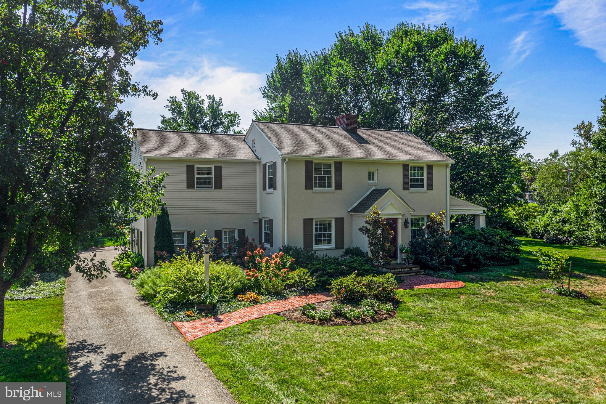 Welcome to 219 S. Ithan Avenue, a classic  4 BD, 2.5 BA colonial on an oversized .86 acre lot in the popular BROWNING  LANE neighborhood of Bryn Mawr. Set in the award-winning Radnor School District, this charming home features many updates and an expansive lot. Inside, the renovated Kitchen overlooks a sunny Family Room addition, creating the perfect hub for gatherings and everyday living. Two Butlers Pantry areas in the Kitchen provide additional cabinet space and are great for entertaining. Enjoy hosting friends and family for meals in the Dining Room. The Living Room has built-ins, a fireplace, and a door to a covered side Porch, which could easily be enclosed to create a private Office.  Upstairs, the Primary Bedroom is a true retreat with multiple closets and a renovated en suite Bath featuring a marble-topped vanity and a glass-enclosed stall shower. Three additional Bedrooms share a well-appointed Hall Bath, providing comfort and versatility for family or guests. The Lower Level offers a finished space that can be used as a Recreation Room, Playroom, or Home Gym plus a large unfinished Utility/Storage/Laundry Room. Sturdy stucco over solid block construction. Enjoy summer barbecues on the expansive rear patio, and recreation or gardening in the beautifully landscaped yard, surrounded by mature plantings for privacy. The 2-car rear entry Garage adds extra ease to daily life.  This home is part of the sought-after Browning Lane neighborhood, which has a warm sense of community and activities that foster lifelong friendships. Easy access to top-ranked schools, including Radnor Elementary, and within walking distance to restaurants, train stations, Villanova University, Agnes Irwin School, parks, and playgrounds. Convenient to the Blue Route, Center City, Airport, and to shops and restaurants in the charming villages of Wayne and Bryn Mawr. Don't miss the opportunity to make this exceptional property your own.