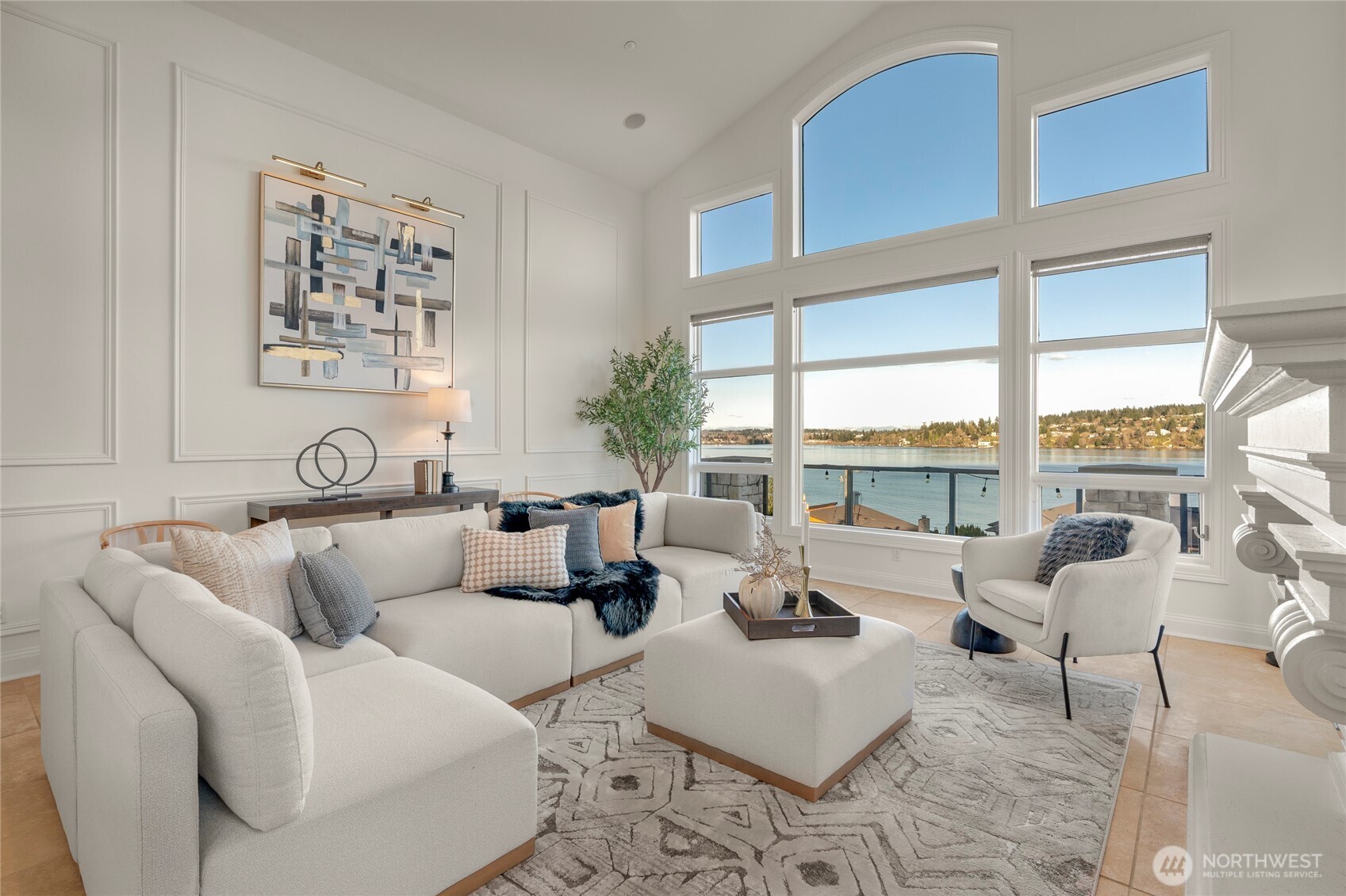 Immediate lake access, sweeping Lake Washington, Cascade and Mt. Rainier views, paired with luxury and the ideal layout, this custom-built residence offers a rare Sheridan Beach opportunity! With over 5,000 sqft, soaring ceilings throughout and walls of windows, the home is beautifully designed to incorporate views into daily living. The chef’s kitchen with oversized island and walk-in pantry opens to expansive gathering spaces and a stunning wraparound view deck. Level front and back yards - a true rarity in Sheridan Beach - complemented by a private garden retreat and covered back patio with ceiling-mounted heater for year-round enjoyment. Upper-level primary suite features a sitting area, sensational views and large walk-in closet. A private-entry MIL suite below with no-step access and second kitchen provides flexibility for guests, extended living or possible rental use. Direct access to the Burke-Gilman Trail just outside the driveway awaits your daily dose of walking or biking or simply connecting with nature. Feel the special energy of watching activity on both the lake and the trail. Convenient to Seattle and the Eastside, within the stellar Shoreline School District, and eligible for associate membership to the Sheridan Beach Club. Best of all, direct lake access just 30 seconds from the house through a secluded public access point just in time for summertime! Don’t miss this magical lifestyle of Sheridan Beach living.