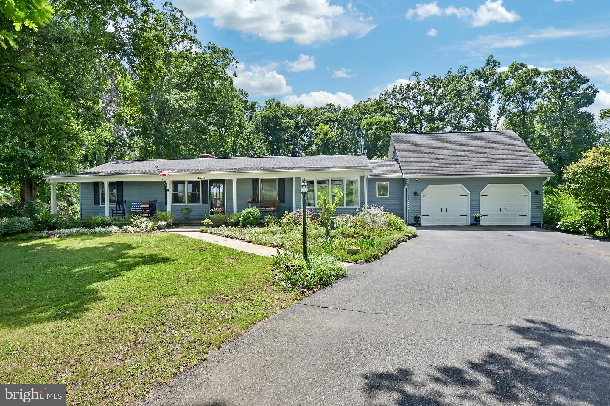 Country living at its finest—just minutes from downtown Purcellville shopping, dining, and major commuter routes! Nestled on a picturesque 1-acre lot with pastoral views out front and serene wooded open space behind, this beautifully maintained 3-bedroom, 2-bath ranch offers the ultimate rural retreat. Relax on the charming, full-length front porch or step into the fully fenced backyard oasis featuring 2 chicken coops, an inground vinyl pool (new pump 2026), a spacious composite deck, and a lower patio with a fire pit.Automotive enthusiasts and entrepreneurs will appreciate the attached 2-car garage plus a impressive 30x32 detached 3-car shop equipped with a 100-amp subpanel. The double-bay side serves as a workshop, while the climate-controlled single-bay side features independent heating and A/C—ideal for the current home gym, an office, or studio space. Major mechanicals and finishes have been thoroughly updated, including the roof, siding, and most windows (2017), kitchen appliances (2019), HVAC (2020), washer/dryer (2021), both bathrooms (2022), and hot water heater (2025). Truly a turn-key gem!