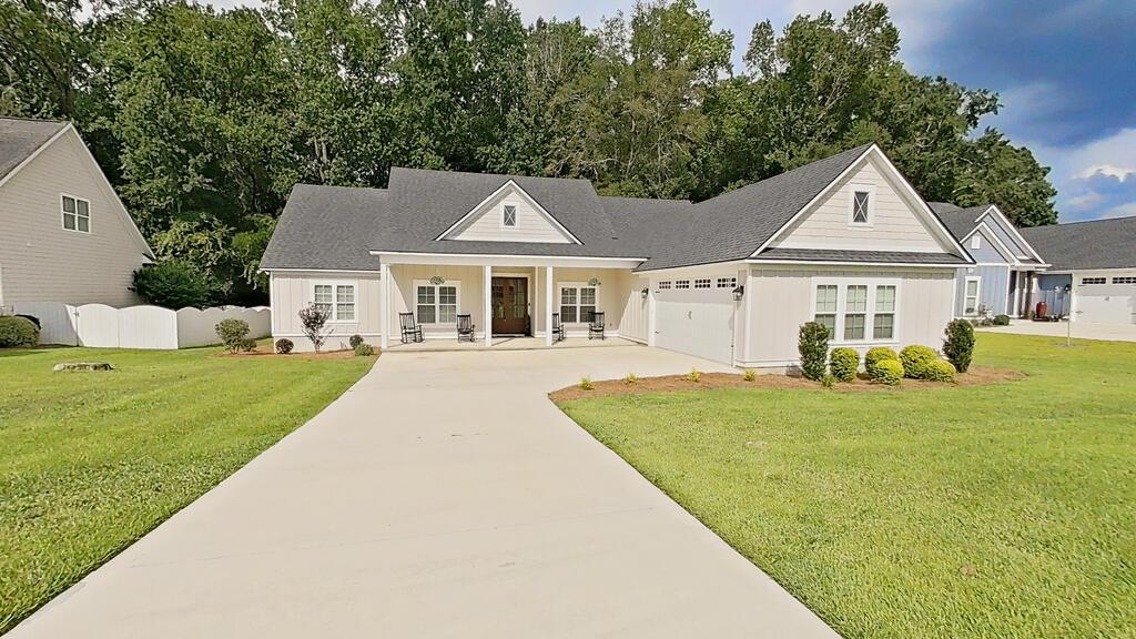 Welcome to this elegant and beautifully maintained home in the desirable Madison Grove community! Featuring 4 bedrooms, 2 baths, plus a spacious upstairs bonus room, this home offers a thoughtful split-bedroom floor plan with plenty of room for everyday living and entertaining. Double solid wood entry doors lead into the spacious foyer, featuring laminate flooring throughout and Livingroom has a cozy gas-log fireplace with a brick hearth. The formal dining room provides the perfect setting for gatherings, while the large kitchen offers an abundance of cabinetry, tile backsplash, generous workspace, and a convenient breakfast room with bay windows.The spacious primary suite provides plenty of room for a sitting area and features a luxurious bath with a soaking tub, walk-in tiled shower, double vanities, and a large walk-in closet with custom wood shelving. Three additional bedrooms offer generous closet space and share a well-appointed bathroom with double sinks and a tub/shower combination with tile surround. Upstairs, the bonus room offers endless possibilities and would make an excellent teen retreat, media room, home office, or additional living space. A convenient half bath is located nearby, along with the walk-in laundry room. Step outside to enjoy the covered patio and additional grilling deck overlooking a private backyard with peaceful wooded views. The oversized garage provides ample room for two vehicles—including a truck—plus a golf cart and additional storage. Residents of Madison Grove enjoy wonderful community amenities, including a community pool, fitness center, meeting space, and beautiful neighborhood walking areas. This exceptional home combines elegant finishes, spacious living areas, privacy, and an outstanding community setting—truly a home you will want to see!