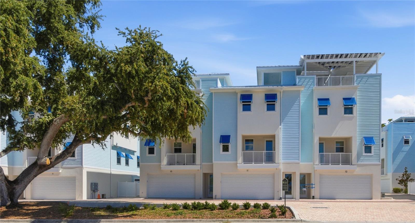 Desirable Dunedin! This is your opportunity to own a brand-new, never-lived-in 2025 townhome in this boutique waterfront-inspired community that allows short-term rentals. This fantastic townhome was built with durability, style, and everyday comfort in mind, this impressive ICF-built townhome offers 2,759 square feet across four spacious levels, complete with a private 4-stop elevator running from the oversized 4-car garage all the way to the rooftop terrace. From the top level, enjoy incredible partial views of Clearwater Beach, Caladesi Island, and the Intracoastal Waterway.  The main living level was designed for gathering and entertaining, featuring 10-foot ceilings, engineered wood flooring, smooth-finish walls, and an open-concept layout filled with natural light. The kitchen includes granite countertops, real wood shaker cabinetry, upgraded stainless appliances, a large center island with gas range, and a walk-in pantry. This floor also offers two balconies, a half bath, and a flexible office or bonus space. Upstairs, the owner’s suite includes two built-in closets, a large bath with soaking tub, frameless glass shower, and dual vanities. Two additional bedrooms, another full bath, and a conveniently located laundry area complete the third floor.  At the top, the private rooftop terrace is the perfect spot to relax, entertain, or catch one of Dunedin’s beautiful sunsets over the Gulf.  Mira Vista homes are constructed using Insulated Concrete Form (ICF) construction, offering exceptional energy efficiency, sound reduction, moisture resistance, and hurricane protection with a 235-mph wind rating. Additional upgrades include Miami-Dade impact windows and doors, 8-foot solid-core interior doors, LED lighting, Hardie siding, and oversized gutters.  The community features a private paved street, coastal-inspired architecture, Florida-friendly landscaping, and small private yards perfect for entertaining or pets. Located along the Pinellas Trail, Mira Vista is just a short walk or bike ride to downtown Dunedin, Honeymoon and Caladesi Islands, local restaurants, marinas, and waterfront spots.