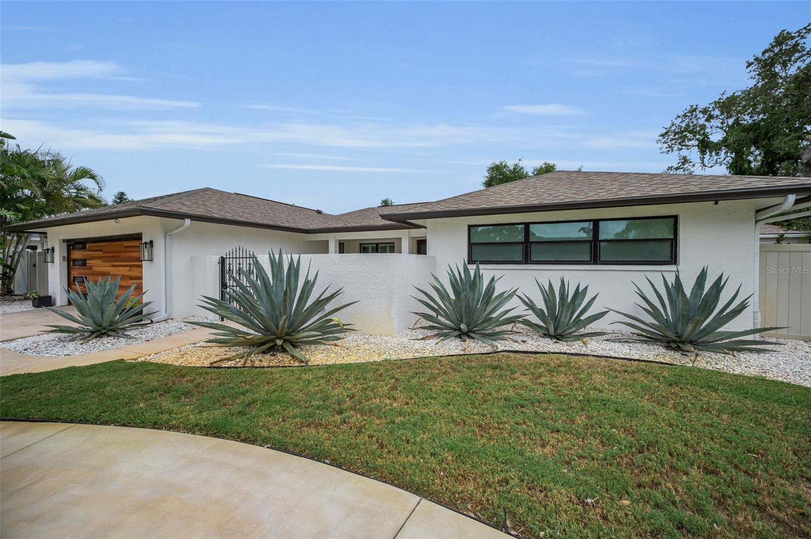Welcome to the Exquisite Enclave of Bay Hills, where winding, tree lined streets and a serene ambiance define one of Pinellas County’s most Prestigious neighborhoods. Perfectly positioned just minutes from the Gulf's world-famous sugar sand beaches and high & dry with no flood insurance, this Impeccably maintained Executive Pool home offers the ideal blend of luxury, comfort, and coastal living. Nestled on a large, tropically landscaped lot (98x123) with exceptional privacy, this beautifully renovated, one-level residence features 3 bedrooms, 2 bathrooms, approximately 1,900 square feet of thoughtfully designed living space, an oversized two-car garage, along with an highly functional circular driveway. Every detail has been carefully updated with quality craftsmanship and timeless style. Designed for both everyday living and effortless entertaining, the wide-open, Sun filled split-bedroom floor plan showcases beautiful wood flooring throughout, new impact windows (2025), new roof (2025), plantation shutters, automatic blinds, and a newer screen enclosed, heated pool with paver deck patio (2021). A new and totally separate 24' x 12' workshop/storage building offers endless possibilities for hobbies, a home gym, studio, or additional storage. At the heart of the home is a stunning, contemporary Chef's Kitchen featuring a stylish center island, sleek black cabinetry, premium Kitchen-Aid appliances, abundant counter space, and views overlooking the resort-style pool area. The kitchen flows seamlessly into the sun-drenched Family room, allowing the Cook to stay connected with family and guests while entertaining. The welcoming foyer at the entry opens to elegant Living and Dining spaces filled with natural light, while the expansive 28' x 14' Great Room offers incredible flexibility for entertaining, relaxing, or hosting family gatherings. Step outside to your own private backyard paradise. The resort-inspired outdoor living area features a large heated, screen-enclosed pool surrounded by beautiful travertine pavers, and an additional seating area with a stylish gas fire pit, creating the perfect setting for year-round outdoor living and unforgettable evenings under the stars. The spacious Primary Suite is just off the entry, and it features a generous walk-in closet, and a beautifully remodeled full bath with double sinks and an oversized walk-in shower. Two additional bedrooms are privately situated on the opposite side of the home, both offering generous closet space, including one walk-in closet and sharing a beautifully updated full bath. The back guest bedroom also enjoys triple sliding glass doors leading directly to the backyard oasis. An upgraded, inside utility room featuring refined cabinetry, a utility sink, and a stacked laundry system, oversized two-car garage, circular driveway, and ample storage complete this exceptional property. Located in the highly desirable Bay Hills community of Largo, this Like-New Ranch-style home offers the perfect combination of tranquility and convenience. No flood insurance is required, and you'll enjoy easy access to top-rated Seminole schools, shopping, dining, parks, and recreation. Whether you're searching for a year-round residence or the perfect Coastal retreat, you'll love being just minutes from Florida's breathtaking Gulf beaches while enjoying one of the area's most established and desirable neighborhoods. This exceptional home truly offers the very best of Florida living.