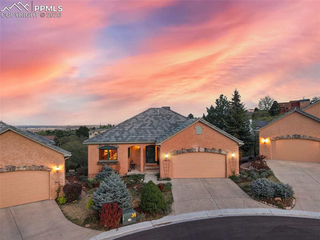 Tucked at the end of a quiet cul-de-sac, this exceptional .43-acre property offers the best of Colorado living with sweeping city views to the east and stunning mountain vistas to the west. Thoughtfully positioned to capture both sunrise and sunset, this is truly a one-of-a-kind setting. Lovingly maintained, the home showcases easy, low-maintenance living with a classic stucco exterior, tile roof, and an expansive composite deck perfectly oriented to take in the views. Inside, warm wood floors and an open, airy layout immediately welcome you. A wall of windows to the east floods the home with natural light while framing the beautiful scrub oak and natural terrain beyond.The kitchen is both functional and inviting, featuring staggered cabinetry, stainless steel appliances, soft-close drawers, a center island, stylish backsplash, and a charming dining nook with picturesque mountain views. Vaulted ceilings, recessed lighting, and a cozy gas fireplace enhance the adjoining living space, creating an ideal environment for both everyday living and entertaining. The seamless flow between indoor and outdoor spaces makes gatherings effortless.The main level also offers a private, tucked-away study which is perfect for work or quiet retreat or library. The primary suite is a true sanctuary, complete with dual closets, built-in shelving, a walk-in closet, and direct access to the deck. The ensuite bath features a jetted tub, standalone shower, and tile flooring. The walk-out basement expands your living space with a comfortable area to relax or entertain, opening to a patio with a hot tub.  It's your own private retreat under the Colorado sky. Additional highlights include abundant storage, dual water heaters, and quality finishes throughout.A rare opportunity to own a home that perfectly blends comfort, views, and privacy in an unforgettable setting.  All the conveniences are just minutes away....shopping, restaurants, golf club, hiking trains and so much more.