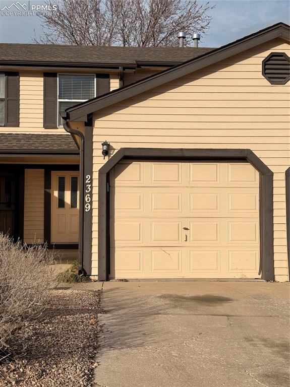 Spacious townhome-style residence featuring an attached 1-car garage and a functional open-concept layout. The main level offers a combined living and dining area with a cozy fireplace, ceiling fan, and sliding glass door that opens to a private fenced patio—ideal for outdoor seating or entertaining. The kitchen includes ample cabinetry, black appliances, Tile countertops, and a breakfast bar overlooking the living space. Interior finishes include wood-style flooring on the main level and neutral wall colors throughout. Convenient main-level half bath and dedicated storage areas. Located in an established community with mature trees and close proximity to shopping, dining, and major commuter routes. Property presents an excellent opportunity for personalization or investment.