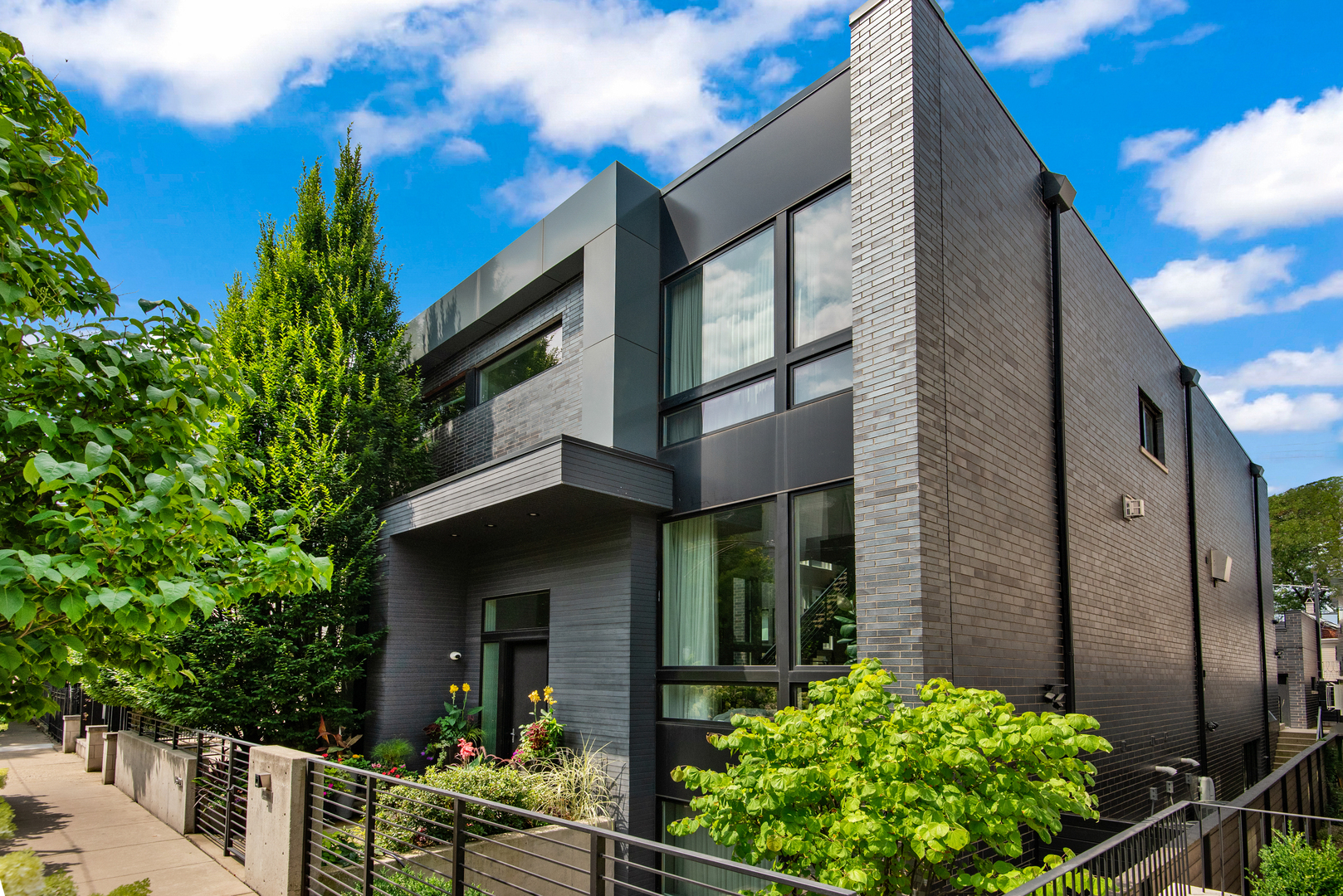 Absolutely stunning entertainer's dream home on a double lot with indoor/outdoor lifestyle on sought after Wolcott in the heart of Bucktown. This immaculate 6 bedroom 6.5 bath home boasts over 7,000 sf with an ideal floor plan, soaring 11ft ceilings, floor-to-ceiling windows, and 5" quarter sawn white oak flooring throughout. The sleek chef's kitchen features custom Ernestomeda dark wood and grey lacquered cabinetry, oversized waterfall island, separate Miele refrigerator and freezer, dual Miele dishwashers, 60" Wolf Professional range with dual ovens, grill, griddle, and warming lights. Butler's pantry w/ beverage refrigerators, ice maker, and 2nd sink. Main level features formal living room/dining room with double sided fireplace, plus an additional spacious dining area as well as a bright home office with full bathroom all overlooking a clever center courtyard which has a putting green letting in tons of south facing light. Primary suite includes large walk-in closet and incredibly spacious spa-like bathroom featuring marble flooring, Ann Sacks tile, oversized shower with 2 rain shower heads and body sprays. Antoniolupi bathrooms throughout. The impressive lower level features radiant heated flooring, two additional bedrooms, 2 full bathrooms (one with steam shower), custom gym, 1500 bottle wine cellar, spacious recreation room with bar and projection screen, and abundant storage. Highly practical mudroom to the garage. Two laundry centers. Incredible professionally landscaped and irrigated outdoor spaces including a fabulous terrace with built-in grill station, backyard with outdoor fireplace and massive garage roof deck over the 4-car garage. Conveniently located with easy walk to the blue line, 606 trail and all of the best shops, restaurants, and cafes in Bucktown/Wicker Park.