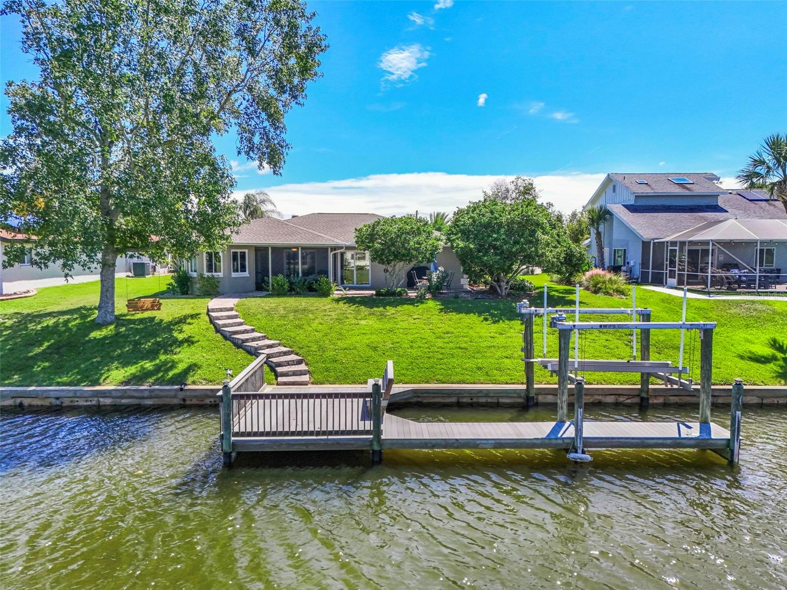 This is where the Palm Coast waterfront lifestyle begins right in your own backyard. Situated on a saltwater canal with approximately 90 feet of waterfront frontage, this well-maintained 3-bedroom, 2-bath home offers the perfect combination of comfortable living and boating convenience.Inside, the home features a bright, welcoming floor plan with generous living and dining spaces and plenty of natural light. The kitchen offers abundant wood cabinetry, ample counter space, stainless-steel appliances and a casual dining area, creating a comfortable gathering space for everyday living and entertaining. The spacious bedrooms provide flexibility for family, guests or a home office.Step outside and the real attraction becomes apparent. A large screened lanai provides a relaxing place to enjoy Florida's year-round outdoor lifestyle while overlooking the backyard and canal. A walkway leads to the waterfront, where your private dock and boat lift make it easy to get out on the water whenever the mood strikes. With 90 feet of bulkheaded canal frontage, there is plenty of room to enjoy the peaceful waterfront setting, launch an afternoon of boating or simply relax and watch life on the canal.The nicely landscaped property, established shade trees and generous backyard create an inviting setting without taking the focus away from the water.  Whether you're searching for a full-time residence, seasonal Florida retreat or waterfront home built around the boating lifestyle, 8 Fleming Court deserves a closer look. Come experience saltwater canal living in Palm Coast.
