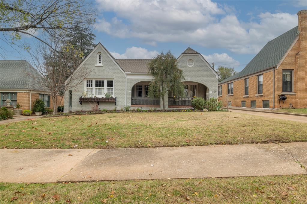 This brick Tudor sits in the heart of Edgemere Park, one of Oklahoma City’s nine historic neighborhoods. Established in 1926 as a progressive alternative to the city’s traditional grid, Edgemere Park was designed with curved streets centered around an area creek and expansive communal green spaces. Its original vision emphasized shared parks over private backyards, creating a neighborhood defined by connection, openness, and architectural charm. This home reflects those ideals beautifully. The covered front porch is accessorized by double arches, scoured concrete, and wrought-iron rails. Inside, details have been preserved with care: heavy wall texture in the living and dining areas, graceful arches throughout, art niches, original lighting, and a stunning coffered barrel ceiling—each feature contributing to the home’s timeless character. The living room's crown jewel is the one-of-a-kind fireplace, inspired by family shields and sailing adventures and nicely finished with its accompanying brass heat insert.The kitchen has been thoughtfully opened and expanded to create an easy, welcoming flow ideal for entertaining large groups. A breakfast bar and adjacent serving buffet amplify the kitchen's optionality. Just off the back door, a newly created mudroom area allows for practical uses. The main level includes three bedrooms and two full bathrooms, while a finished carpeted flex space upstairs offers room for a studio, playroom, office, or quiet retreat. Space has been maximized on the second floor, providing an above-average amount of finished storage space and attic access. A basement and lofted garage each provide additional space.Outside, the property is enhanced by a full two-car garage, a raised deck perfect for outdoor gatherings, and a fenced yard that balances privacy with the neighborhood’s tradition of communal green space.Character, quality, and a uniquely Edgemere Park sense of place- that's what 237 NW Eubanks Street has to offer.