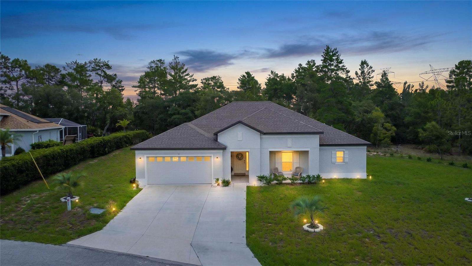 Nestled on a quiet cul-de-sac in the highly sought out Sugarmill Woods golf and country club community, this stunning 2024-built home delivers modern luxury from the moment you arrive. A large front porch invites you to sit and unwind, while an extra-wide driveway and 2-car garage set the tone for the quality that awaits inside.Step through the entry into a huge foyer that welcomes you into an open-concept living space designed for effortless style and comfort. High ceilings throughout create an airy, spacious feel, while sleek luxury vinyl flooring flows seamlessly across the entire home, paired with granite countertops in every space that calls for them — from the kitchen to the bathrooms. The kitchen impresses with sleek appliances and a breakfast bar, perfect for casual mornings or entertaining guests.The living area centers around a beautiful fireplace, while elegant plantation shutters adorn every room, adding warmth and sophistication throughout the home. With 4 bedrooms and 2 bathrooms across 2,291 square feet, there's abundant space for family, guests, or a home office — complemented by large walk-in closets offering exceptional storage. The primary bathroom features a double sink vanity, adding everyday convenience and a touch of spa-like luxury to your morning routine.Extend your living outdoors on the expansive extended lanai, where peaceful greenbelt views create a natural setting. It's an ideal setting for morning coffee, evening relaxation, or entertaining.Modern construction, thoughtful design, and an unbeatable location backing up to green space — this Sugarmill Woods gem is ready to welcome you home.