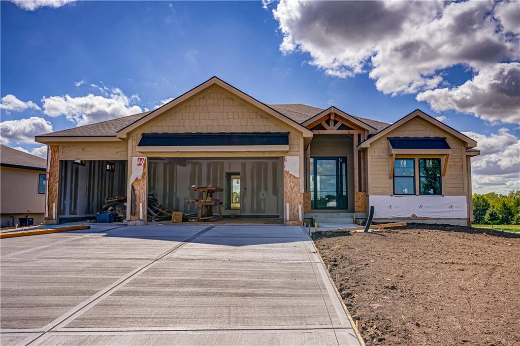 Welcome to exceptional new construction by Brian Cheney in Lake Winnebago. This beautifully designed third tier 4 bedroom, 3 1/2 bath home offers two bedrooms on the main level and two additional bedrooms on the finished walkout lower level.The main level is designed for both everyday living and entertaining, featuring a spacious living room with a fireplace framed by custom built-ins and a beautiful wood mantle. The kitchen is anchored by a large counter-height island and 36" gas cooktop, creating a natural gathering space. Six-ply engineered hardwood floors extend throughout the main living areas, complemented by plush designer carpet in the primary suite and upgraded tile in the primary bath and laundry room.The spacious primary suite offers beautiful lake and pool views, plus a dedicated sitting area. The spa-like bath features a freestanding soaking tub, zero-entry shower with glass enclosure, and an oversized walk-in closet. Conveniently located just off the primary closet, the laundry room adds functionality to the thoughtfully designed layout.Step outside from the main level living room onto the composite deck, where a stone covered fireplace creates the perfect setting for relaxing or entertaining outdoors.The finished walkout lower level offers plenty of room to spread out, with LVT flooring throughout the main living areas, plush carpet in both bedrooms and closets, and an 8' ceiling height. A large island provides additional entertaining space, with room for a full-size refrigerator and built-in microwave. The lower level also features a bar and living area, convenient half bath, and plenty of space for a game table or recreation area.Additional highlights include a three-car garage, distinctive stone and lap siding exterior, a beautifully trimmed entry box vault, and quality finishes throughout. Designed for the way you live, this Lake Winnebago home offers the space, style, and indoor-outdoor living you've been looking for.