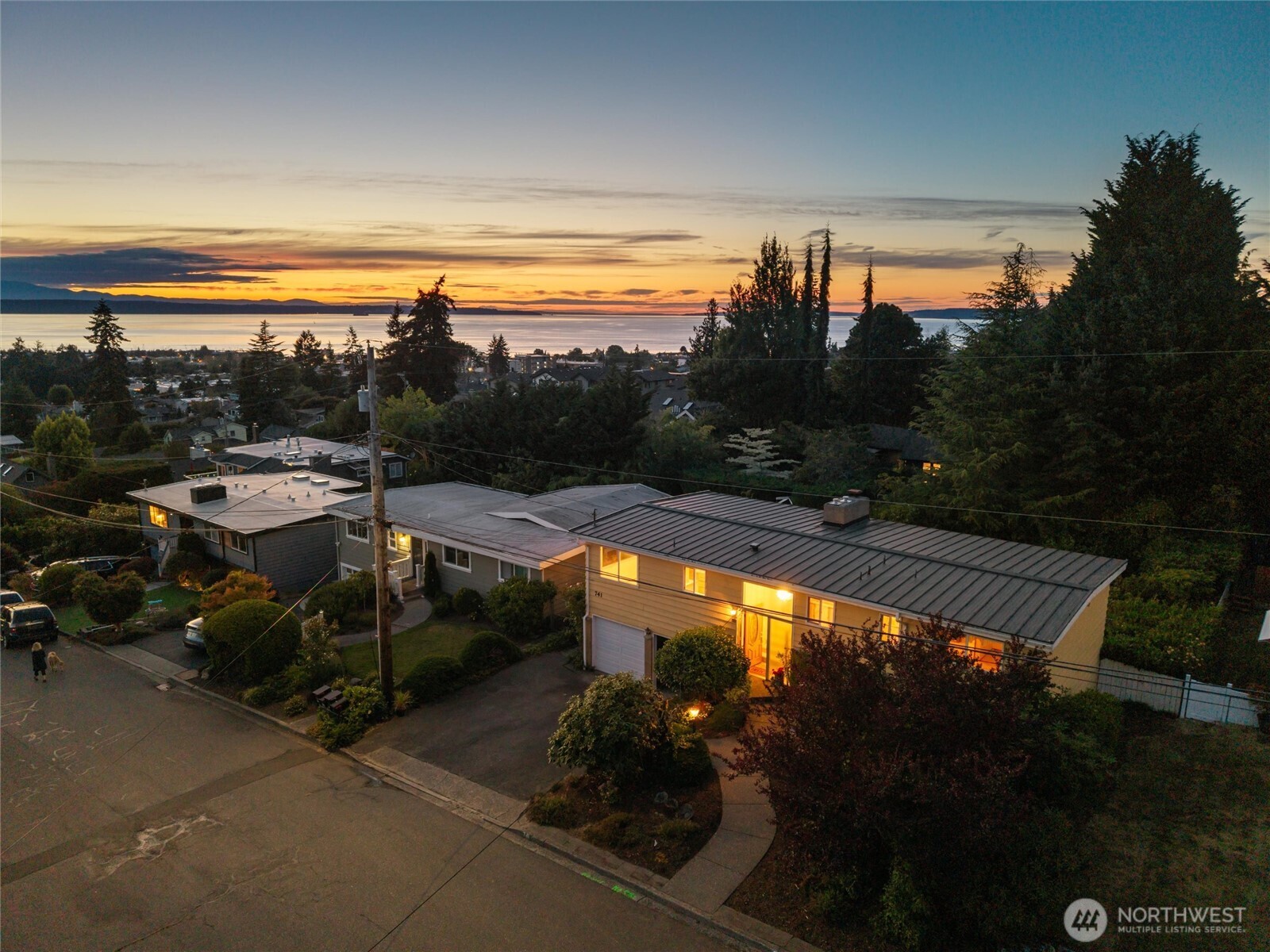 This home is ALL about the view! In the heart of the Edmonds Bowl, this original-owner home offers Puget Sound and Olympic Mountain views, a private setting, and an opportunity to create your dream home. Tucked on a quiet street, blocks from downtown Edmonds, this split-level offers 2,028 square feet w/ 4 bedrooms (one is non-conforming), 2.75 baths, and generous spaces ready for its next chapter.  The light-filled main level features a spacious kitchen w/ abundant workspace, living and dining areas, a cozy gas fireplace, and large picture windows framing views of the incredible Puget Sound view.  The daylight lower level adds flexible living space with a rec room, wood-burning fireplace, non-conforming 4th bedroom, 3/4 bath, and slider to the patio. The heated two-car garage includes a workbench and additional storage.  The backyard is a peaceful retreat, with mature rhododendrons, fruit trees, garden space, and a pond.   All of this just blocks from downtown Edmonds, walking distance to shopping, restaurants, cafés, beaches, the marina, ferry, & farmers market.  A rare Edmonds Bowl opportunity with sound views, timeless character & the chance to make a well-loved home your own. Come see it for yourself. (Please note some photos are virtually staged). Up to 1% credit with listing agent’s preferred lender.