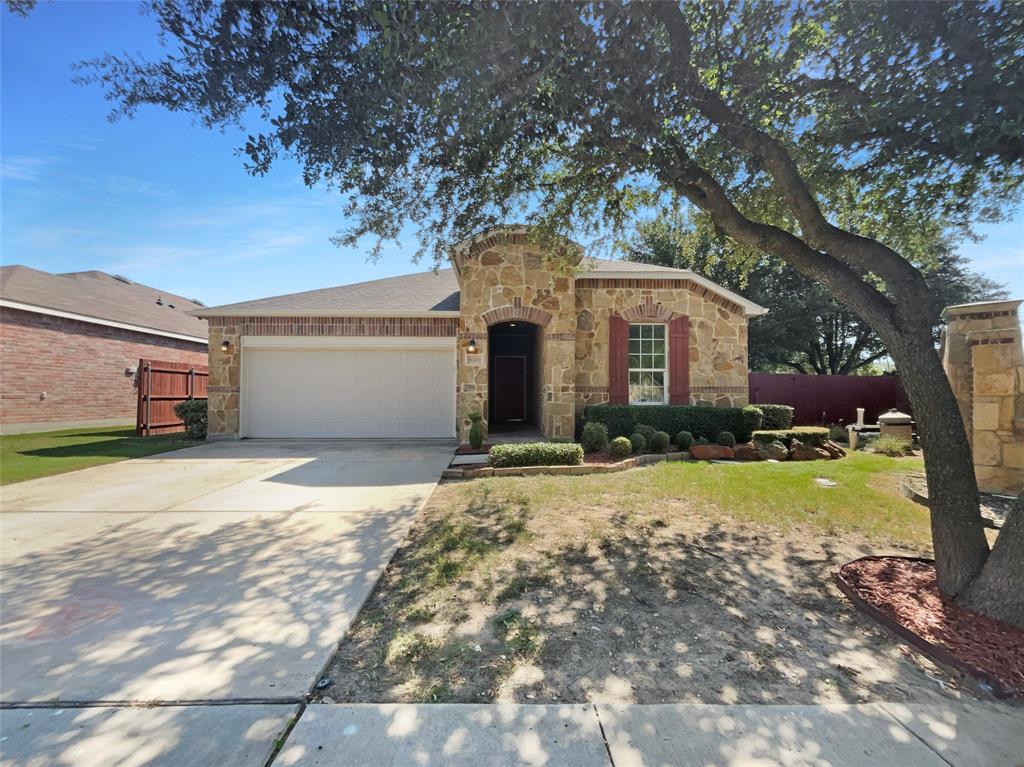 Welcome to this beautifully updated home! The living room boasts a cozy fireplace and a neutral color paint scheme, providing a warm and inviting atmosphere. The kitchen is a chef's dream with a center island, accent backsplash, and all stainless steel appliances. The primary bedroom features a walk-in closet, and the primary bathroom offers a separate tub and shower for ultimate relaxation. Fresh interior paint and partial flooring replacement add a modern touch to this charming home. Outside, you'll find a covered patio perfect for entertaining. This home is a must-see! This home has been virtually staged to illustrate its potential.. Included 100-Day Home Warranty with buyer activation