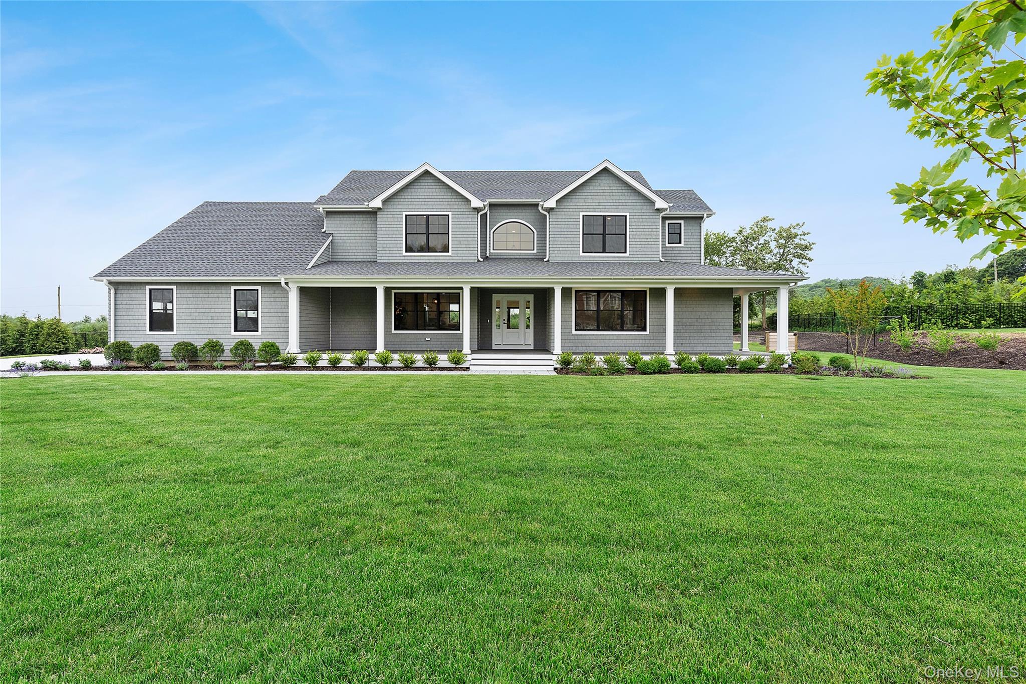 Price Improvement and a fantastic investment that will yield countless priceless memories and financial gain. This ultra-custom residence, which is both furnished and finished, is literally a one-of-a-kind new construction home and boasts 4 bedrooms and 3.5 baths.   The CO was just received, and it includes municipal approval to accommodate seven full bedrooms and additional bathrooms!  This brand-new floor plan design, which has never been built before, represents the last chance to purchase in the otherwise sold-out Oasis at Mattituck development. Nestled on just shy of 1 acre of manicured land, and just moments from the pristine, residents-only Breakwater Beach and Mattituck Inlet Boat Launch, the residence is turnkey and dripping with luxury. Maibec Eastern White Cedar dipped shingle exterior, a three car side entry garage an expansive wrap around porch, a dramatic open-concept first floor plan with 6-inch-wide plank white oak floors which creates a soaring entry foyer, a bespoke chefs level kitchen, a Cambridge quartz island with designer 2.5” mitered edge paired with a gorgeous full-height backsplash, double-stacked premium cabinetry and a professional grade appliance package,  and very attractive high end furniture -all designer selected and coordinated are just a few of the extravagant inclusions.  The first floor also includes a spacious primary suite featuring a spa-worthy bathroom. The second floor has an additional spacious primary bedroom suite as well as large secondary bedrooms, each with a walk-in closet. The magnificent lower level, featuring 10 ft. volume ceilings, an outside entrance, and three egress windows, can be further customized with three additional legal bedrooms and bathrooms! The property's vast grounds are also extraordinary, as the backyard includes a 20’ x 40’ heated saltwater pool, a custom-designed masonry patio, and a built-in masonry fire pit, all of which overlook countless acres of open space. Will Not Last!