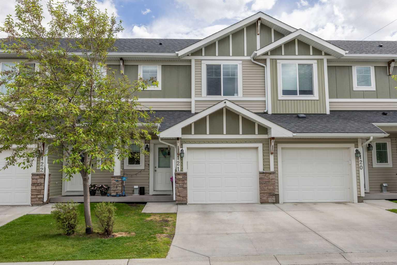 Welcome to 121-300 Marina Drive, a bright and beautifully maintained two storey townhouse offering an ideal combination of comfort, functionality, and location in the heart of Chestermere. The home features an insulated single attached garage with additional storage space, plus parking on the driveway for a second vehicle. Inside, the open concept main floor is filled with natural light and showcases durable laminate flooring throughout the living and dining areas. The thoughtfully designed U-shaped kitchen is both stylish and practical, featuring granite countertops, newer stainless steel appliances, ample prep space, and seating for casual meals or entertaining. The inviting living room is anchored by a cozy corner gas fireplace, creating the perfect space to relax at the end of the day. Step outside to the sunny south facing backyard, where you'll enjoy all day sunshine. The fenced yard includes a convenient BBQ gas line, making outdoor dining and entertaining a breeze. Upstairs, the spacious primary bedroom offers a private retreat complete with a walk-in closet featuring a window and a full ensuite bathroom. Two additional bedrooms are generously sized and share a second full bathroom. The upper level laundry room adds everyday convenience and includes a stacked washer and dryer along with extra storage space. The basement is unfinished and provides an excellent opportunity for future development, allowing the next owner to create additional living space tailored to their needs and lifestyle. Located in the sought after community of Westmere, this home offers exceptional access to everything Chestermere has to offer. Residents enjoy nearby parks, pathways, schools, shopping, restaurants, and, of course, beautiful Chestermere Lake. Whether you're spending summers on the water, exploring the extensive pathway system, or taking advantage of the city's growing amenities, you'll appreciate the welcoming small town atmosphere while remaining just a short drive from Calgary. This is a fantastic opportunity to enjoy a low maintenance lifestyle in one of Chestermere's most desirable communities.