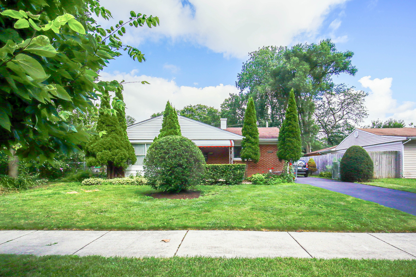Welcome to this beautifully maintained and thoughtfully extended brick ranch nestled in the heart of Wheeling's desirable Dunhurst subdivision. Recent (and peace-of-mind) upgrades: Central AC (2025), furnace (2024), complete plumbing (2009), roof (2022), dishwasher (2024), washer (2020), and majority of windows and sliding door (2019).   Interior layout includes a warm living room with hardwood floors, a cozy family room with wood-laminate flooring centered around a classic brick fireplace, and a ceramic-tiled eat-in kitchen-perfect for gatherings. Functional spaces: In-unit laundry, lots of natural light, and a smart room layout that includes three nice-sized bedrooms-all offering comfort and style  Detached 2-car garage, long driveway, and asphalt parking ensure ample parking and ease. Brick exterior, concrete perimeter foundation. Conveniently close to parks, shopping, dining, and local amenities-offering suburban serenity and accessibility. Walking distance to Mark Twain Elementary and Wheeling High School.