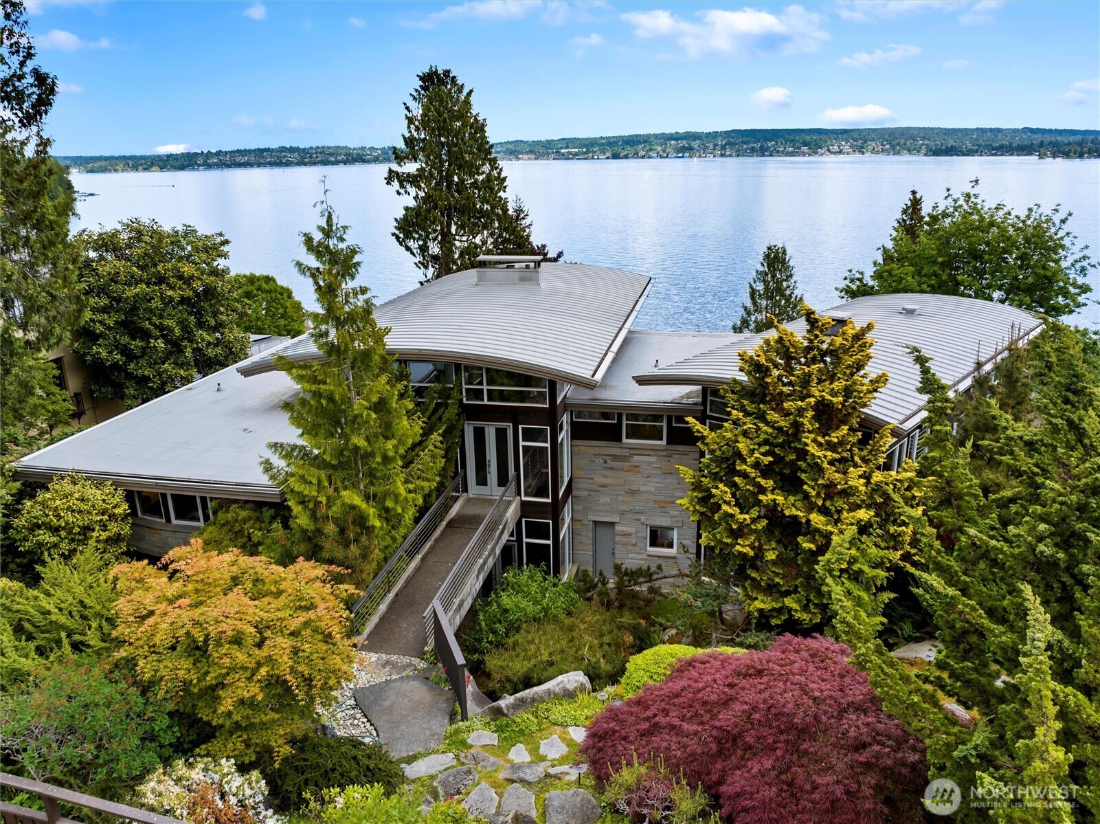 Exceptional Laurelhurst 1.17 acre Lake Washington waterfront estate w/155’ of prime frontage! 6,488SF 5BR 5.5BA home w/elegant atrium entry w/standing granite stone, barrel ceilings & walls of windows w/sweeping views of the sparkling waters of Lk WA, Mt Rainier & the Cascades, & golden sunrises from nearly every room. 2000 built one-of-a-kind masterpiece w/unique spaces & NW wood finishes, expansive view decks & patios, & 4 car garage. Arboretum-like grounds w/mature plantings & winding walkways to level lakeside gardens, walk-in cove & 95’ private dock on 2 lots. A+ location near Laurelhurst Beach Club, U-Village & easy commute to Seattle & Bellevue. Don’t miss this rare opportunity to own one of the great Laurelhurst waterfront retreats!