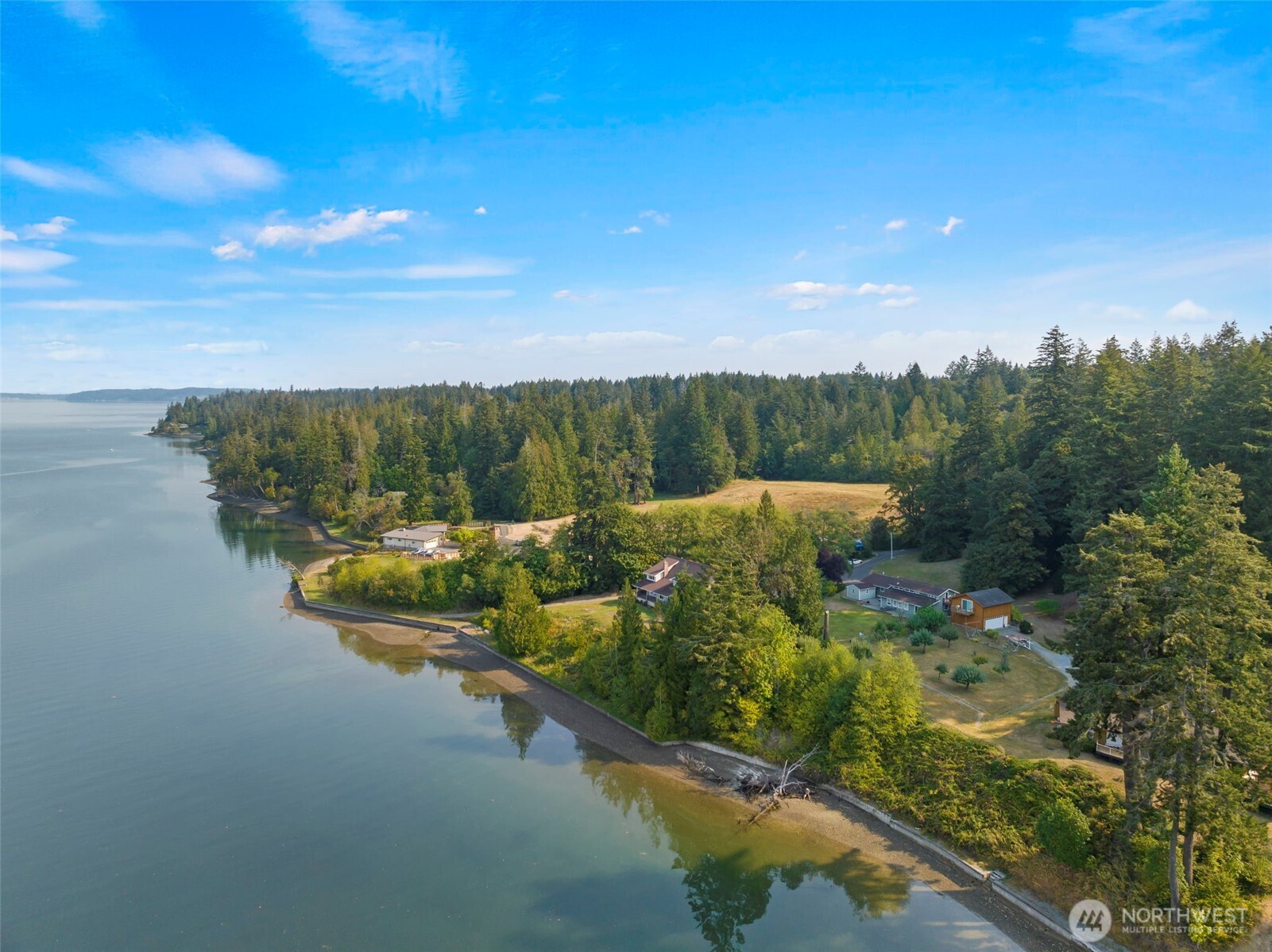 Affordable waterfront on quiet Henderson Inlet on a large level lot! Great water views. Concrete bulkhead. Plenty of outdoor recreation space w/ play structure. Detached 1-car garage. Private well. Roomy storage building. Clean and well-kept rustic cabin is just waiting for your updates!