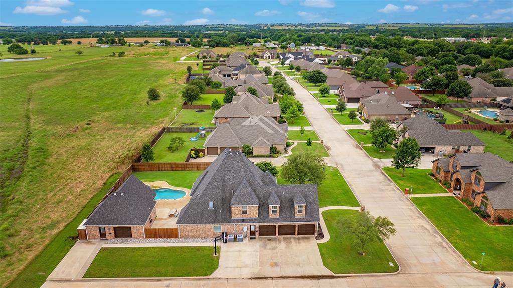 A Big Opportunity in Lindsay, TX!

Step into Nortman Estates and discover a spacious 3-story home with room for everyone—and then some. At 3,491sf, this house offers 5 bedrooms, 4 bathrooms, plus an office with custom built-ins, and a 720sf pool house ready for weekend fun.

The home features a primary suite on both the first and second floors, designed to accommodate any phase of life. The kitchen is a showstopper with granite counters, stainless appliances, and a built-in refrigerator. Throughout the home, you’ll notice thoughtful touches like built-ins, trayed ceilings, crown molding, and a 250sf screened porch perfect for sipping coffee or winding down after a long day. The unfinished third floor is a world of possibilities—imagine it as Christmas storage overload, an art studio, game room, media lounge,  or whatever inspires you most. 

Step outside and you’ll find an entertainer’s dream: a sparkling pool with a built-in hot tub and rock waterfall, a pool house with a bathroom and kitchenette, an outdoor shower, plenty of patio space, and a 238?sf covered porch for shaded relaxation.

Sitting on a large corner lot with no backyard neighbors, the property also boasts a 3-bay garage with two parking spots and a workbench area, a sturdy privacy fence, and extra room for parking. Recent updates include fresh interior paint, exterior touch-ups, and brand-new carpet.

Utilities include Pentex Electric, Atmos Natural Gas, and City of Lindsay, and the home is part of the highly regarded Lindsay ISD.

This is more than a house—it’s a lifestyle waiting to be enjoyed in a small town full of charm and dreams !