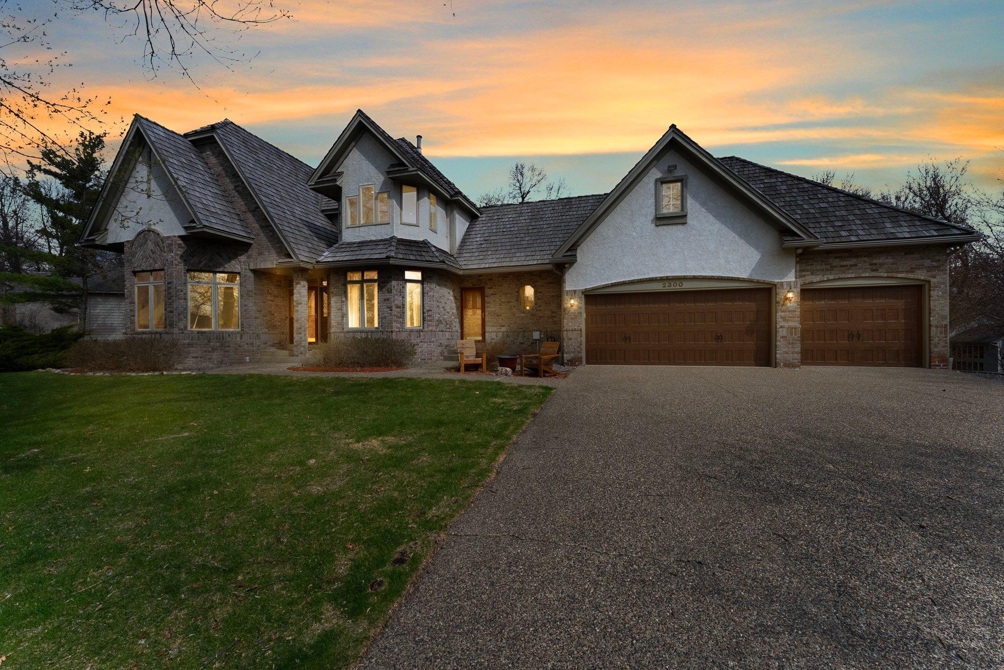 This exceptional 4-bedroom, 4-bathroom home is nestled in a private cul-de-sac within a quiet neighborhood, conveniently located near dining, shopping, and major highways. The home features striking architectural details and modern comforts, making it ideal for both entertaining and daily living. Upon entry, you are greeted by a grand foyer with 18-foot ceilings, an elegant chandelier, wood flooring, and a striking staircase. The chef’s kitchen is equipped with ample white cabinetry, granite countertops, a built-in Wolf cooktop, and a center island with high-top seating. The informal dining room, with a bay window and access to a spacious 24x14 deck, offers seamless indoor-outdoor entertaining. The formal dining room features wood flooring, coved ceilings, a classic chandelier, and a large bay window. It includes a wet bar with a sink, marble countertops, white cabinetry, and a built-in wine rack, perfect for hosting guests. The main-level family room is generously sized, filled with natural light, and boasts plush carpeting, elegant wood wainscoting, and a cozy wood-burning fireplace. The living room features crown molding, rich wood floors, and a large bay window. The main-level office is designed for productivity, featuring large windows, wood wainscoting, crown molding, glass French doors, and warm wood flooring. The laundry room, conveniently located near the attached three-stall garage, offers tile flooring, generous cabinetry, and a utility sink. A half bathroom is also on this level.
Upstairs, the primary suite is a spacious retreat with plush carpeting, coved ceilings, and a large bay window overlooking the backyard. The luxurious ensuite bathroom includes granite flooring, a double vanity, a walk-in shower with multiple showerheads, and a soaking tub. The suite also features a generous 8x6 walk-in closet. Bedrooms two and three share a Jack and Jill bathroom, which includes a tub/shower combination and a granite-topped vanity. Both bedrooms are spacious with carpeting, ceiling fans, and ample closet space. The finished basement offers a large recreation area with a stylish bar, featuring a center island, beverage fridge, ice maker, sink, and microwave. The adjacent family room includes a wood-burning fireplace and access to the outdoor patio. A den with rich wood flooring, built-in bookshelves, and French doors adds elegance, while the bonus room can serve as a dressing area or additional living space. The fourth bedroom on the lower level is spacious and includes a ceiling fan, plush carpeting, and serene backyard views. French doors lead to the outdoor patio, and a ¾ bathroom is nearby, making this an ideal guest suite. The lower level also includes access to an additional attached garage, perfect for a workshop or storage. The backyard offers privacy with mature trees, a 20x12 shed with a loft, and plenty of space for outdoor entertaining, including a 28x15 paver patio and a 24x14 deck. This home combines unique architectural design, ample amenities, and a tranquil location, making it the perfect place to call home.