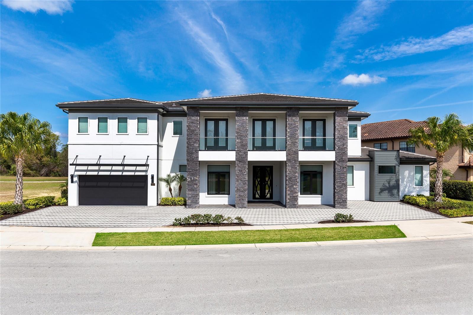 Elite 10-bedroom custom home in Reunion Resort with a proven rental track record. This spacious layout is ideal for large groups and offers everything today’s vacation home buyers are looking for, including a full game room, private theater, sports bar/media area, and a resort-style screened pool deck with summer kitchen.The home is thoughtfully designed and well-finished throughout, with multiple gathering spaces and custom touches across both levels. The kitchen features an oversized island with seating, double ovens, two dishwashers, and a large refrigerator/freezer—perfect for entertaining. A large dining area comfortably accommodates family and guests.Primary suites are located on both floors, each offering walk-in showers, soaking tubs, double vanities, and additional seating areas. The remaining bedrooms are well-appointed and designed for comfort and flexibility.Whether you’re looking for a personal retreat or an income-producing property, this home checks all the boxes. Take a look through the photos and virtual tour to fully appreciate everything it has to offer.