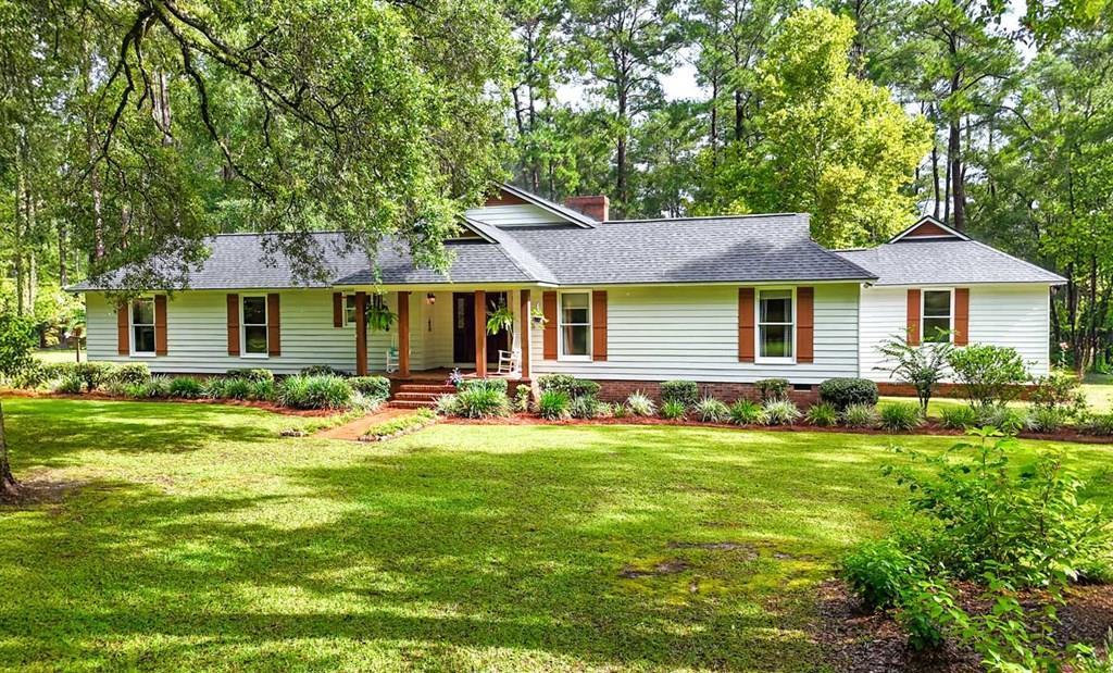 Tucked away on nearly three private acres in Plantation Woods, this beautifully updated home offers the perfect blend of peaceful country living and everyday comfort—just minutes from everything Thomasville has to offer. From the moment you step inside, you'll be welcomed by soaring tongue-and-groove ceilings, rich hardwood floors, and a stunning wood-burning fireplace that anchors the expansive living room. Whether you're hosting family gatherings or enjoying a quiet evening at home, the spacious layout is designed for making memories. The thoughtfully updated primary suite provides a relaxing retreat with a beautifully renovated bathroom featuring dual vanities, a soaking tub, separate shower, and generous his-and-her closets. A dedicated office offers the flexibility to work from home, create, or simply enjoy a quiet space of your own. Step outside and discover what truly sets this property apart. The large covered back porch invites you to slow down and enjoy peaceful mornings overlooking the property, while the fenced area is perfect for pets. Need extra space? The detached workshop with an upstairs bonus room creates endless possibilities for hobbies, a game room, fitness space, or the ultimate man cave. Recent improvements—including a roof and HVAC approximately five years old, a two-year-old well, fresh interior and exterior paint, and a beautifully renovated primary bathroom completed in 2026—provide added confidence and value. If you've been searching for a home that offers privacy, character, modern updates, and room to enjoy the outdoors without sacrificing convenience, 103 Plantation Lane is one you won't want to miss.