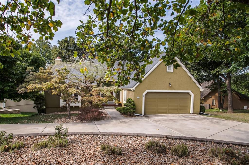 You won’t want to miss this charming Reverse in Lakewood! Immaculately maintained, this home boasts soaring floor-to-ceiling windows in the Great Room with tall ceilings offering amazing space and light, and a large full dining area with built in shelving and cabinetry with tile flooring. Enjoy a stylish and very functional  kitchen  with granite countertops and a gas cooktop including all appliances and refrigerator. Just off the kitchen, an inviting all-seasons room offers the perfect spot to relax and take in the view. The convenient main-floor laundry adds to the ease of living.
The spacious lower level is ideal for entertaining with a walk out to the patio, a wet bar, stunning masonry fireplace with gas heat that can warm up the room, and plenty of space for gatherings.  You’ll also find three additional bedrooms, one being used as a private office, and ample storage space.
Step outside to enjoy the all-brick firepit, shady mature trees, and a large outdoor deck—perfect for more outdoor entertaining or unwinding. Don’t wait, this one won’t last!