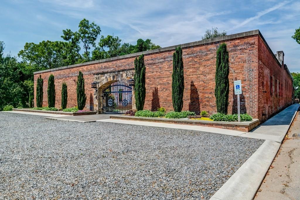 This beautifully restored chic industrial building is located on the scenic Hiwassee River in the heart of Downtown Murphy. You are welcomed by a custom made iron gate that leads you to a pristine and expansive court yard. Inside the double doors is a large open area offering an upscale urban yet rustic feel with 14 ft tall ceilings. Fully equipped commercial-grade kitchen with high end Wolf appliances, sealed concrete counter tops, large pantry and closet. Office area with separate back entrance and men and women's restrooms with stall arrangements. Loading dock makes deliveries easy. Although currently it is operating as an event/wedding venue, it offers many possibilities!
