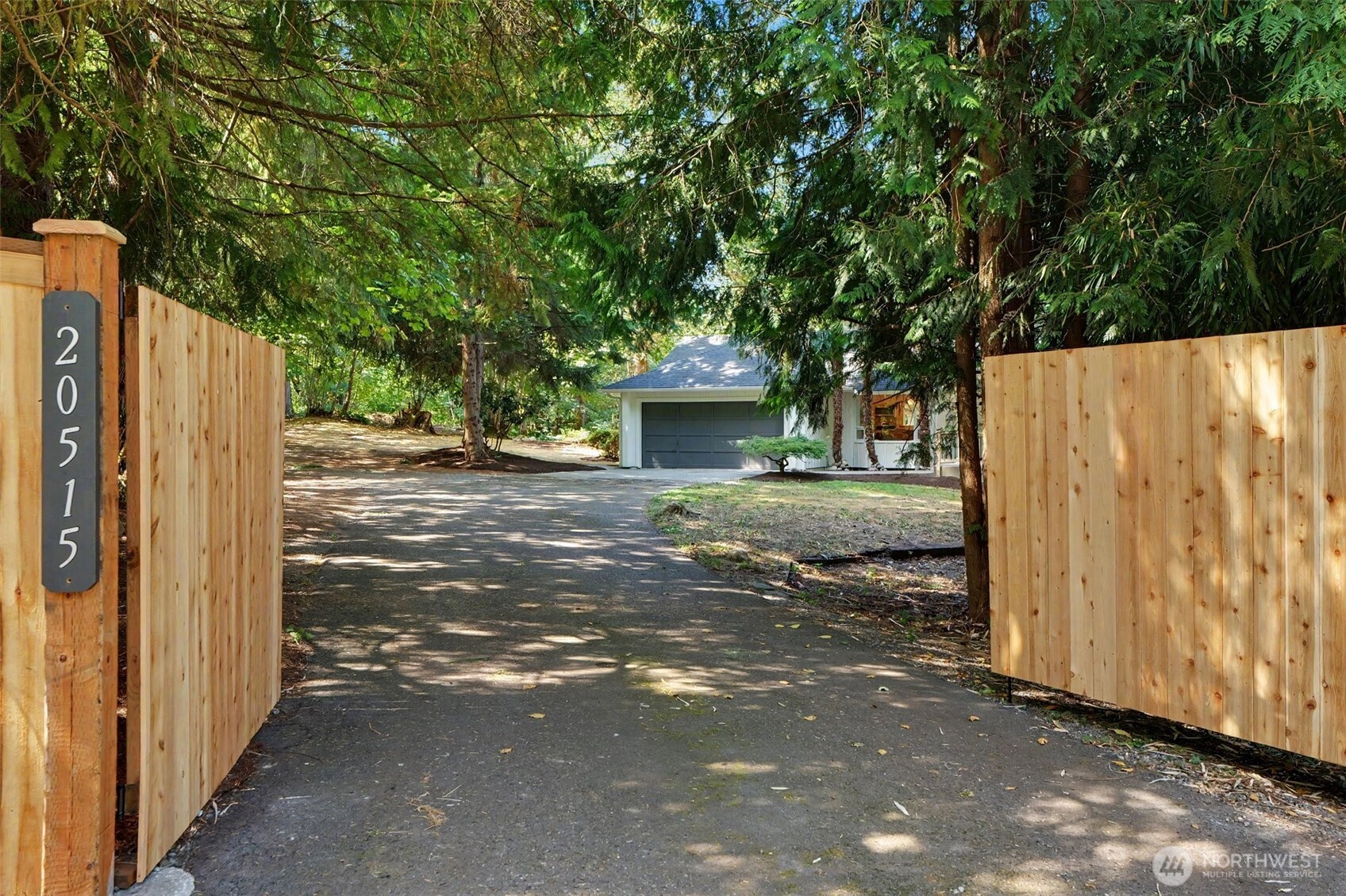 Gated, private, and fully reimagined by Aced Homes. Behind a new cedar gate at the end of a private drive, this single-level retreat sits on 1+wooded acres — no stairs, no neighbors in sight.    Vaulted ceilings open to a great room anchored by a forest-green shiplap wall and linear fireplace with marble surround and cedar mantel. The designer kitchen delivers white oak cabinetry, quartz counters, an oversized island, herringbone tile, gold fixtures, and stainless appliances — flowing out to a full-length covered cedar deck, skylit and rebuilt for rainy-morning coffee.    Three bedrooms, two designer baths, plus a flex room for office or guests. The primary offers a bay window, walk-in closet, and tiled en-suite. Dedicated laundry on the main.    Everything's been touched: new roof, windows, gutters, gated entry, deck, landscaping, and a complete designer interior remodel.    The acreage is the sleeper asset — firepit clearing, two outbuildings, and room for shop, RV/boat parking, garden, or a future ADU. Attached 2-car garage. Septic.    Minutes to Lake Desire, Spring Lake trails, and Petrovitsky Park. Quick access to SR-169, I-405, and I-90, with Maple Valley, downtown Issaquah, and Bellevue all an easy drive. Country quiet, real commute access.