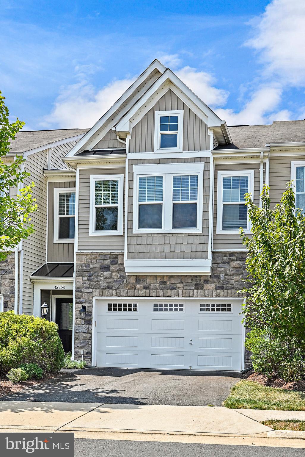 Come to your ideal townhome which was a Model Home at Brambleton Landbay 3  where comfort meets elegance across two meticulously designed levels spanning 2200 SqFt, Boasting 3 bedrooms and 2 full plus 1 half bathrooms. Step inside to be greeted by an abundance of natural light that illuminates the expansive, inviting living spaces, seamlessly connected by stylish and durable upgraded wide luxury vinyl plank flooring where an open layout beckons. spacious great area and  dining area with a premier Gourmet Kitchen equipped with upgraded cabinets, granite countertops, spacious island, and stainless-steel appliances. A Walkout door to the Fenced Backyard with a Beautiful Patio & Lawn Bed featuring beautiful shrubs with New Mulch. Ascend to the upper level and discover a haven of relaxation in the expansive primary suite, complete with 2 generous walk-in closets and a luxurious 4-piece bathroom featuring double sinks and an oversized, frame-less shower with a built-in seat. The two additional bedrooms and full bathroom are perfectly suited to meet your needs and complement your lifestyle. Additionally, this residence includes a 2-car front load garage & asphalt driveway providing both security and convenience for your vehicle. Conveniently located near major routes including 606, 50, 28, and 267. HOA Includes access to 6 Clubhouses, Cable TV + Fiber Optics. Painted Including Ceiling, Upgraded Premium Diamond Carpet + Runner on Staircase with Upgraded Padding. THIS IS A MUST HAVE HOME.