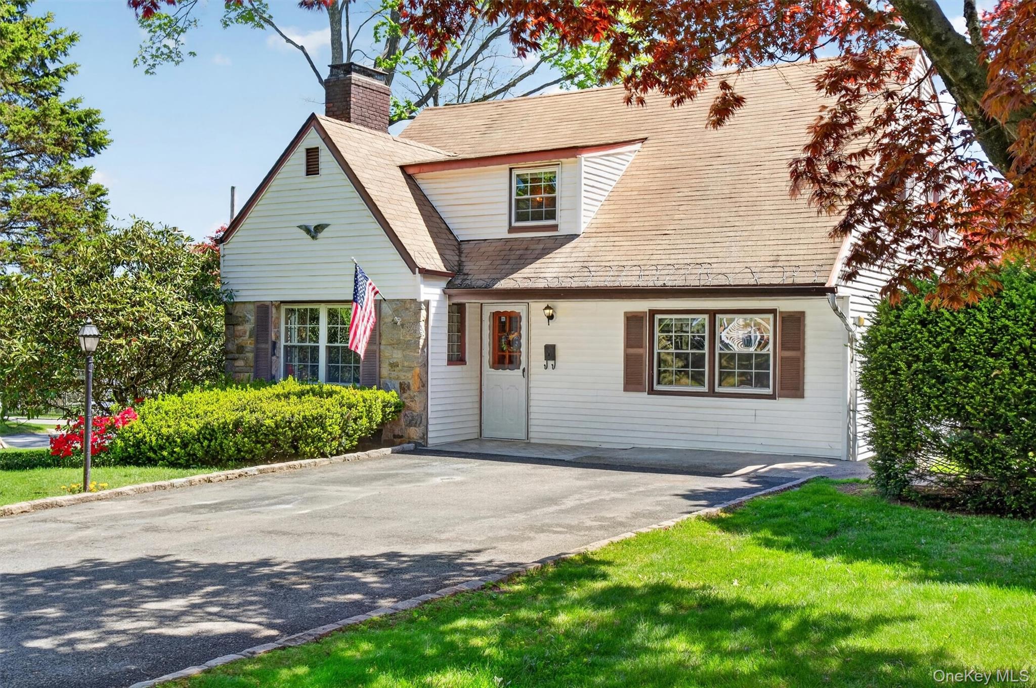 Welcome to 382 Marietta Avenue in the Hamlet of Hawthorne — offered for the first time in 58 years! This charming Colonial features 3 bedrooms plus bonus room that lives like a 4th bedroom, along with 2 full baths and inviting living areas. An entry way welcomes you to the spacious living room with a cozy wood-burning fireplace and Dutch doors leading to a screened-in side porch. The large eat-in kitchen with newer appliances provides plenty of room for everyday dining. The main level includes a family room that can easily function as a formal dining room, as well as an updated full bath with tiled finishes, built-in bench seating, and glass shower doors. Upstairs, you’ll find a spacious primary bedroom with a cedar walk-in closet, two additional bedrooms, and an adjoining bonus room featuring three cedar-lined closets — ideal as an additional bedroom or home office. A full hall bath completes the upper level. The walk-out basement spans the home’s entire footprint and offers an additional 550 sqft. of finished space, including a second wood-burning fireplace, laundry area, and workshop/storage space. With its generous size, the basement offers excellent potential. Enjoy outside gatherings on your large deck overlooking a 100 X 100 CORNER lot w/vegetable garden --- long known for producing the neighborhood’s prized tomatoes! Ideally located --- within close proximity to the Hawthorne Metro-North train station, offering a  45-minute commute to Grand Central and easy access to all major highways and 15 minutes to Westchester County Airport. Don't miss this wonderful opportunity to personalize a beloved property in a sought-after location.