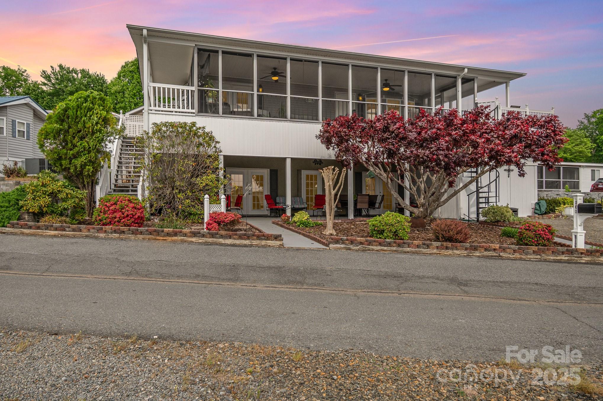This well-maintained modular home sits on a spacious corner lot just across from the water in the gated community of Badin Shores Resort at Badin Lake. Enjoy captivating lake views from the screened porch or open deck—perfect for morning coffee or evening wine. The main floor features an open-concept living, dining, and kitchen area, plus two bedrooms and two full baths. An elevator provides easy access to the lower level, which includes a den, additional bedroom, spacious laundry, full bath, and a versatile bonus room that may be used as an additional sleeping area, game room or home office. A covered lower patio offers the same serene views. With ample parking and storage, this home is ideal as a full-time residence or weekend retreat. Enjoy resort amenities like lake access, swimming pool, sandy beach, fishing pier, putt putt, playgrounds, picnic pavilions, boat ramp and more.