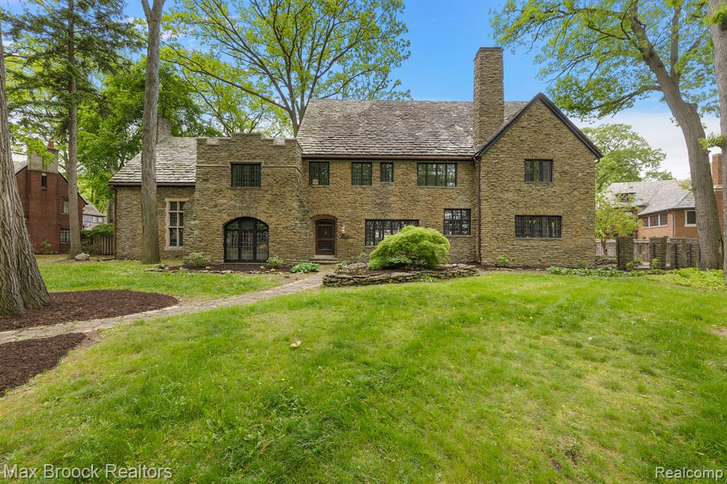Presenting a distinguished 1925 Tudor Revival residence, located in the prestigious Palmer Woods neighborhood, renowned for its exceptional collection of Tudor-style homes. This exquisite property has been meticulously restored, with every detail thoughtfully preserved to retain its original character. Upon entering, the home exudes a sense of old-world grandeur while integrating modern enhancements. The homeowner has painstakingly restored every square inch of the home, including the unprecedented amount of German silver, which has been expertly revitalized. The expansive great room features original wood beams beneath soaring ceilings, complemented by a grand stone fireplace and striking stone walls. The formal dining room, flooded with natural light, offers an elegant setting for entertaining, while an adjoining sitting room provides a serene space with picturesque views. The kitchen has been completely remodeled with custom cabinetry, luxurious stone and tile surfaces, and top-of-the-line appliances, while perfectly preserving the original history of the refurbished Chrysler & Koppin double-sided refrigerator cabinets. Upstairs, the primary suite offers a private space, complete with a sumptuous seating area and a renovated, spa-like en-suite bath boasting custom tile work, an oversized shower, and dual vanities. Completing this level are a spacious laundry room, five additional bedrooms, and four bathrooms that thoughtfully blend traditional elements with modern sensibilities. The third floor offers even more living space, featuring two additional bedrooms and an oversized flex room—ideal for a multitude of purposes. This stunning residence perfectly blends historic elegance with modern convenience, offering a rare opportunity to experience the best this architectural wonder has to offer. Please refer to the attached Restoration Overview document.