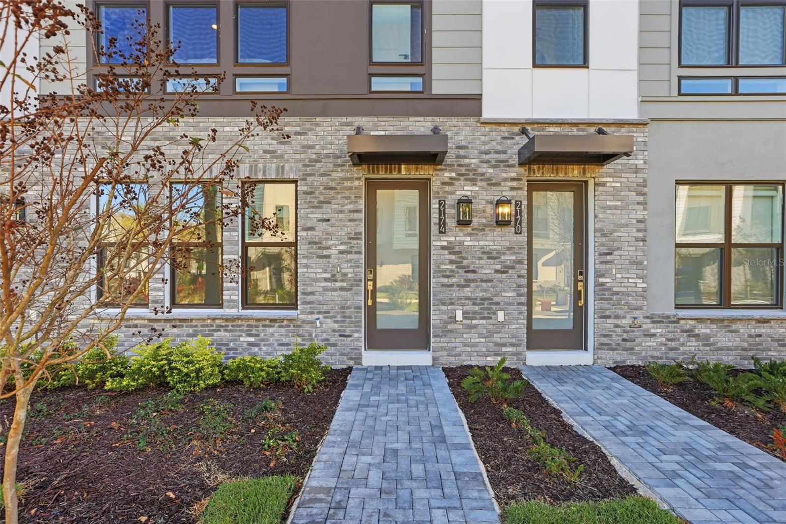 Welcome to The Brix, an exquisite 4-story townhome that lives more like a single-family home, featuring 3 bedrooms and 3.5 bathrooms — plus a stunning rooftop terrace!Enjoy courtyard views from the front with gorgeous landscaping and twinkling lights. The rooftop terrace offers a glimpse of the Downtown Orlando skyline, adding a magical touch to evenings spent outdoors.The first floor offers a convenient bedroom and full bathroom, perfect for guests or a home office. On the second floor, the bright and elegant gourmet kitchen impresses with crisp white cabinetry, a soft off-white tile backsplash, and luxurious white quartz countertops that reflect natural light beautifully. High-end KitchenAid gas appliances, a spacious center island with breakfast bar, and a large walk-in pantry complete this stunning space, perfect for both everyday living and entertaining.Upstairs, the third floor hosts a luxurious primary suite with a generous walk-in closet, along with a second bedroom, full bathroom, and a well-placed laundry room.Capping it all off is the expansive rooftop terrace, prepped for an outdoor kitchen, fireplace, and hot tub, ideal for relaxing or entertaining with stunning views in every direction.The Brix is perfectly situated within close distance to popular amenities including scenic walking/biking trails, the Orlando Tennis Centre, and the YMCA.Schedule your private tour today and experience the elevated lifestyle at The Brix!