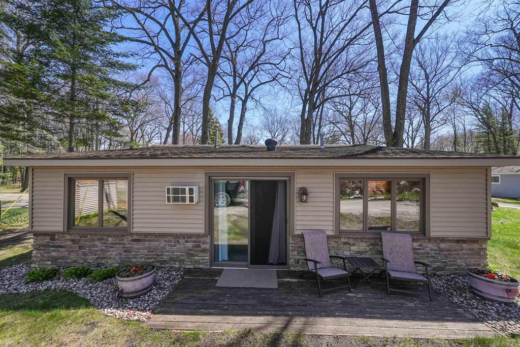 Bring your fussiest buyers this one won't last. Sharing 202' of water frontage on Houghton Lake in Tall Oaks Condominium Association. This 3-bedroom cottage has an open living area with gas log fireplace, knotty pine throughout. The updated bath is complete with ceramic tile shower. Just come to enjoy all the lake and area have to offer. Just bring your personal belongings, most furnishings included except Sectional couch.  You won't be dispointed with this fantastic property.  It has its own marina for your boat and jet skis.  Ample common area to enjoy the Lake.  Association dues cover Lawn cutting and fertilizing, snow removal, dock in and out and a sea wall fund.