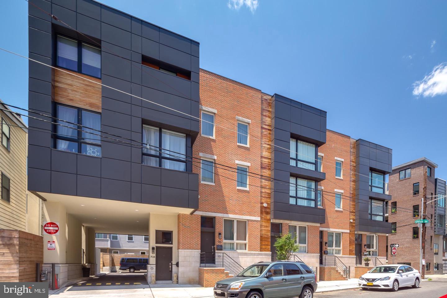 Discover elevated city living at The Marion, an impressive collection of contemporary townhomes located at 4th and Fairmount, right in the heart of Northern Liberties. With more than 2,000 square feet of interior space, a 23 foot wide design, private garage parking, a finished lower level, and a rooftop deck, these homes offer a wonderful combination of space, style, and convenience. The interior welcomes you with rich hardwood floors, soaring ceilings, and oversized windows that bring natural light throughout. The main living level is thoughtfully arranged to provide separate yet connected spaces for relaxing and entertaining, with a spacious front living room leading to the dining area and beautifully appointed kitchen with sleek wood cabinetry, a modern backsplash, generous storage, premium appliances, and a Juliet balcony create a polished, functional space for everyday living. Upstairs, two graciously sized bedrooms offer ample closet space and plenty of natural light, complemented by a full bathroom with a vanity and tiled tub/shower. The third floor serves as a private retreat, featuring a spacious primary bedroom, a separate sitting area, a walk-in closet, and an elegant en-suite bath with dual vanities, a glass-enclosed shower, and a private water closet. The laundry area is also conveniently located on this level. Continue up to your private rooftop deck, where you can unwind, entertain, and take in views of Northern Liberties and the surrounding skyline. A half bath near the entry and a wet bar add extra convenience for hosting guests. The finished lower level provides valuable additional living space, natural light, and storage, along with direct access to the attached garage. Beyond the home, enjoy a fantastic neighborhood setting just moments from local favorite restaurants, plus the many entertainment options throughout Northern Liberties and nearby Spring Garden. With convenient access to public transportation and major roadways, this home delivers the best of comfortable, modern city living. Taxes and square footage is the responsibility of the buyer to verify independently.